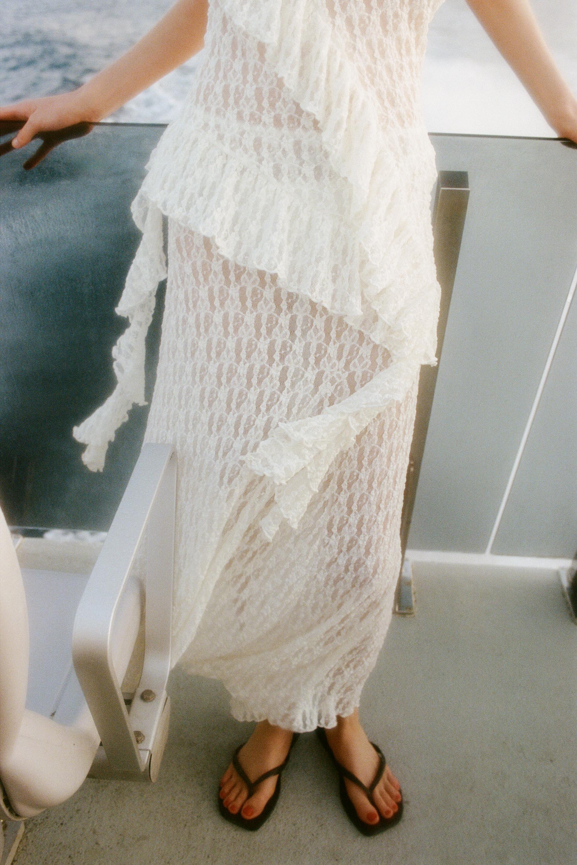 Elevate your wardrobe with the Asymmetric Lace Set, featuring a high-waisted semi-sheer long skirt that offers a comfortable fit with its elastic waistband. The semi-sheer top stands out with an asymmetric neckline and delicate ruffle detailing, adding a refined touch to the ensemble. This set balances elegance and subtle allure, perfect for sophisticated occasions where style and comfort are essential.