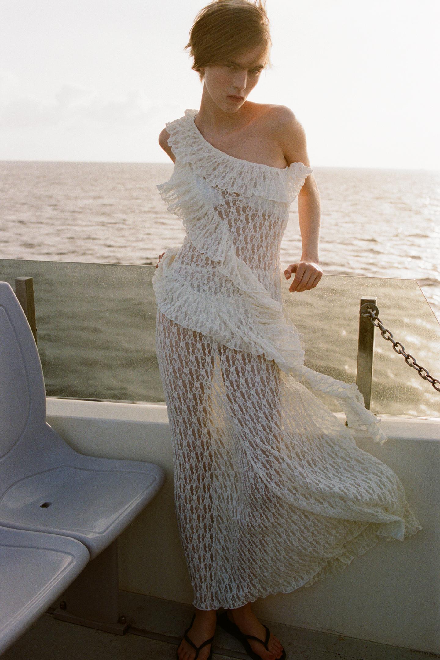 Elevate your wardrobe with the Asymmetric Lace Set, featuring a high-waisted semi-sheer long skirt that offers a comfortable fit with its elastic waistband. The semi-sheer top stands out with an asymmetric neckline and delicate ruffle detailing, adding a refined touch to the ensemble. This set balances elegance and subtle allure, perfect for sophisticated occasions where style and comfort are essential.