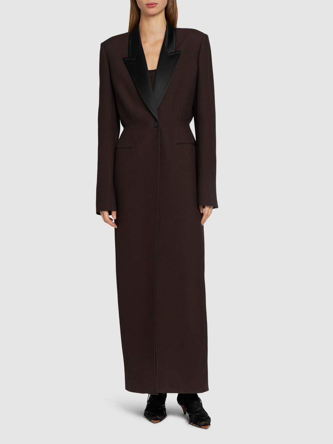 Elevate your outerwear collection with the Bellow Viscose Blend Long Coat by Khaite. Expertly crafted from a luxurious viscose blend, this coat features a clean front button closure and two practical front slit pockets for effortless functionality. Fully lined for comfort and durability, it offers a refined silhouette and timeless appeal, perfect for sophisticated layering in cooler seasons.