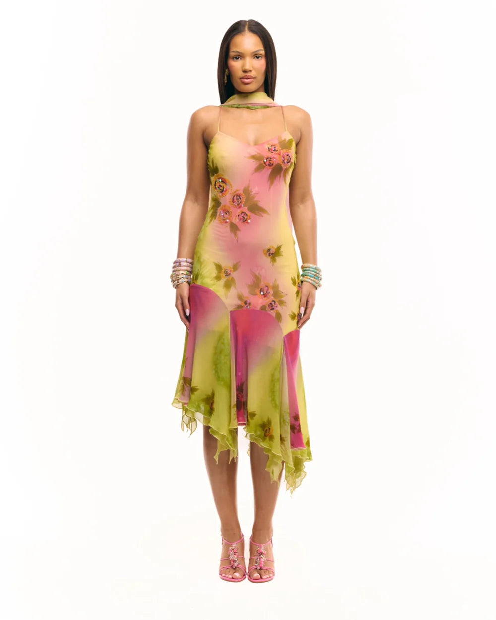 Crafted entirely by hand, the Coral Midi Dress showcases exquisite silk fabric detailed with intricate beadwork and custom floral embellishments in a captivating green and pink gradient watercolor. Its asymmetrical silhouette offers a unique, elegant shape that commands attention, making it a standout choice for refined occasions.