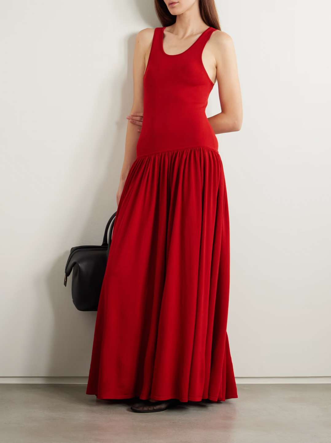 Loulou de Saison's Jada gathered knitted maxi dress expertly combines comfort, detail, and structure. Featuring a scoop neck reminiscent of a tank top, the dress flows gracefully into gathered pleats at the dropped waist, creating a flattering silhouette. Crafted for both style and ease, this red dress offers a refined yet relaxed look perfect for a variety of occasions.