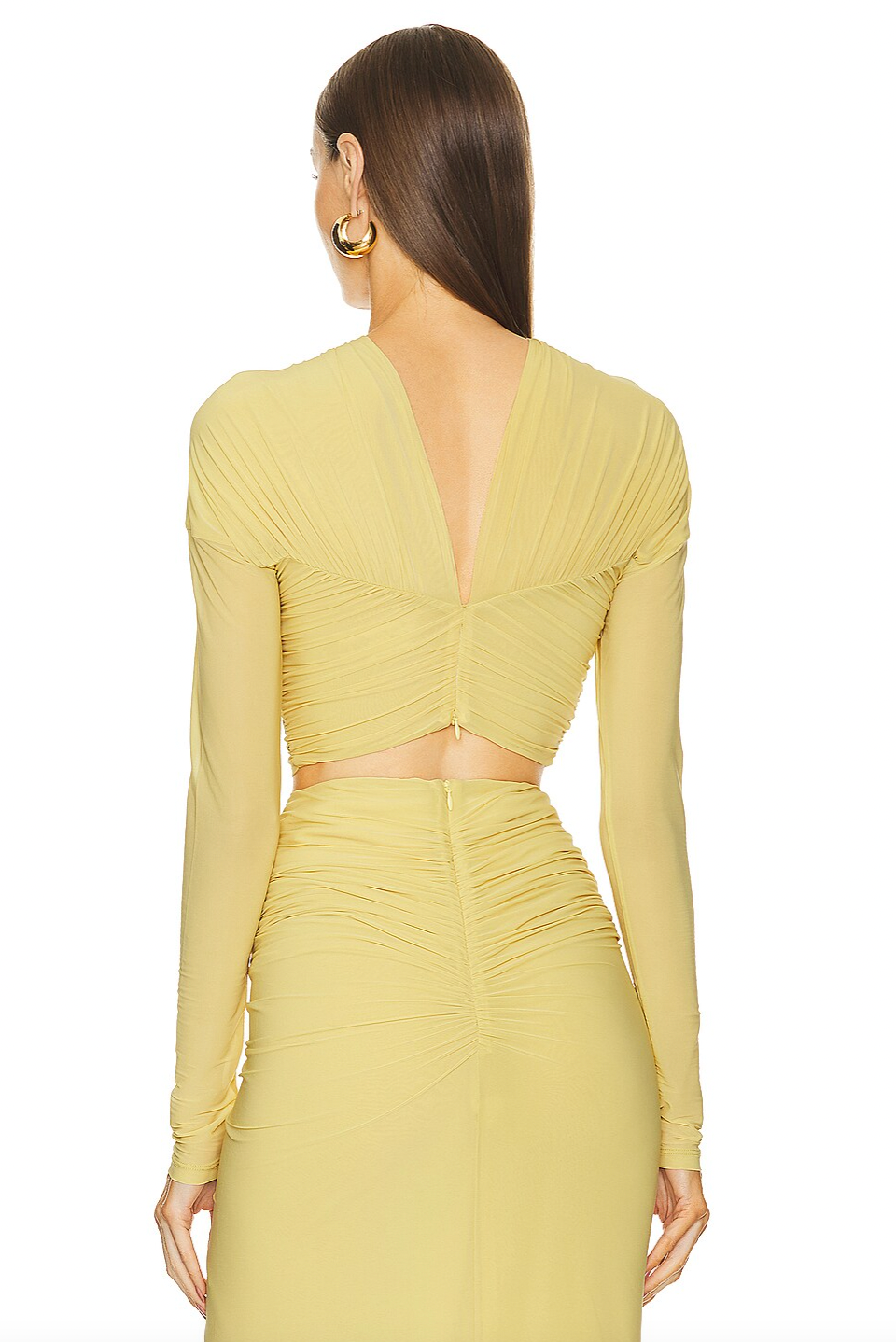 Expertly crafted, the Chase Skirt and Bebe Top by Ronny Kobo features a fully lined design for comfort and structure. Its hidden back zipper ensures a sleek silhouette and easy wear. The ruched slinky jersey fabric offers a sophisticated stretch and subtle texture, enhancing fit and movement. Ideal for occasions where refined style and ease are essential.