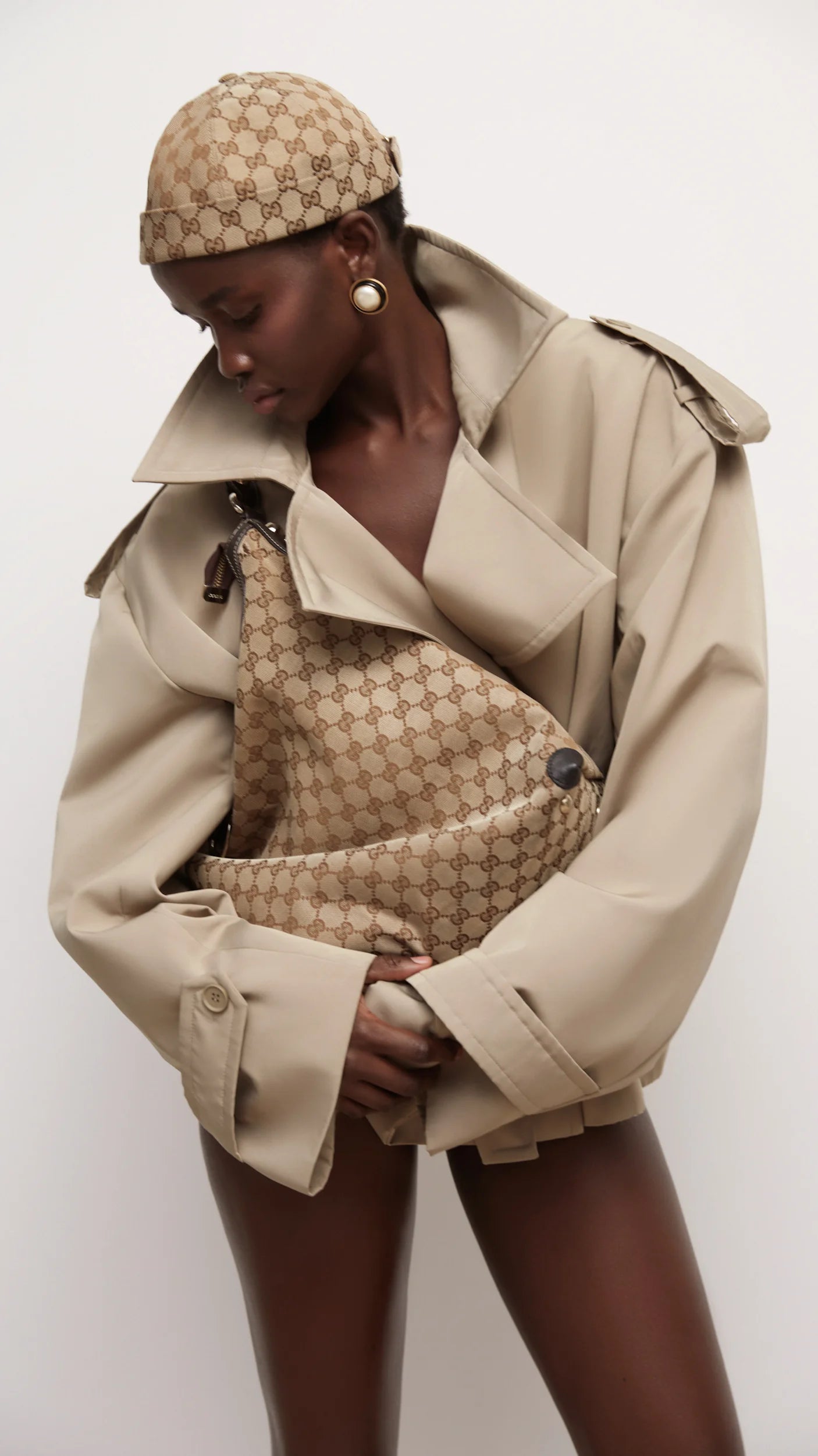 Elevate your wardrobe with this expertly tailored beige trench coat, offering a refined blend of classic design and contemporary appeal. The cropped silhouette enhances layering options, while the neutral beige shade ensures seamless coordination with varied outfits. Crafted for both comfort and style, this trench coat delivers a polished, sophisticated look that adapts effortlessly to different occasions. A versatile essential for a modern, elegant wardrobe.