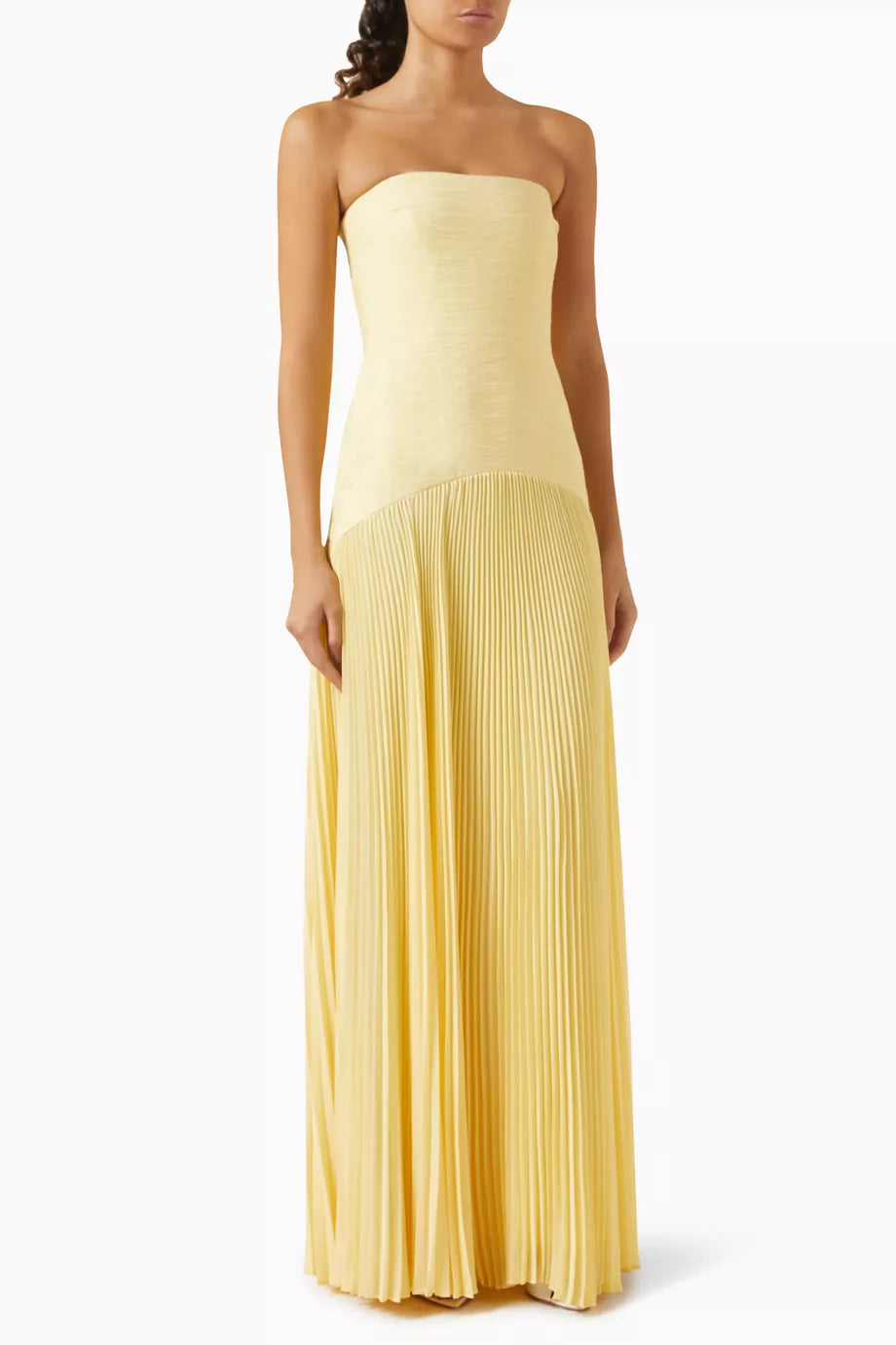 The Sunniva Maxi Dress in Crepe offers a refined silhouette with its boned sides that gently shape your figure, ensuring a flattering fit. Its pleated skirt adds graceful movement, perfect for warm-weather occasions. Designed for minimalism, this dress pairs effortlessly with just a hint of jewelry, making it an expert choice for elegant yet understated summer style.
