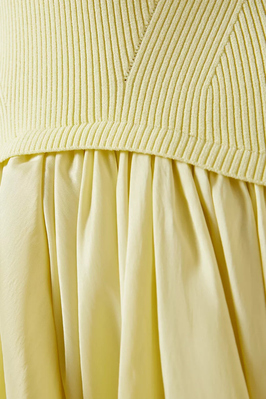 The Kenlie Midi Dress in Rayon Blend by Simkhai offers a sleek minimalist design that expertly enhances your silhouette. Its stretchy knit top contours comfortably, while the A-line skirt creates an elegant hourglass shape. Versatile by nature, this dress seamlessly transitions from casual to refined occasions, delivering both comfort and sophistication with ease.