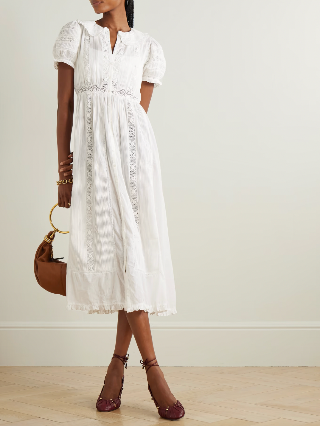 The Phoebe cotton-voile midi dress by DÔEN combines vintage charm with sustainable design. Crafted from organic cotton-voile, it features delicate lace trims and a classic Peter Pan collar. The dress gently cinches at the waist before flowing into a soft, floaty skirt, complemented by subtly puffed sleeves. This piece offers a refined, romantic silhouette ideal for those seeking timeless elegance with eco-conscious materials.