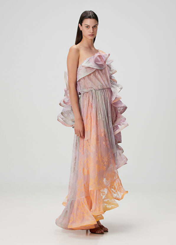 This elegant maxi dress features a distinctive one-shoulder design with an asymmetric neckline that adds a modern touch. Crafted from delicate lace, it offers a refined texture enhanced by flounced detailing and a laced shoulder strap for added sophistication. Perfect for formal occasions, its flowing silhouette ensures graceful movement while highlighting your poise and style.