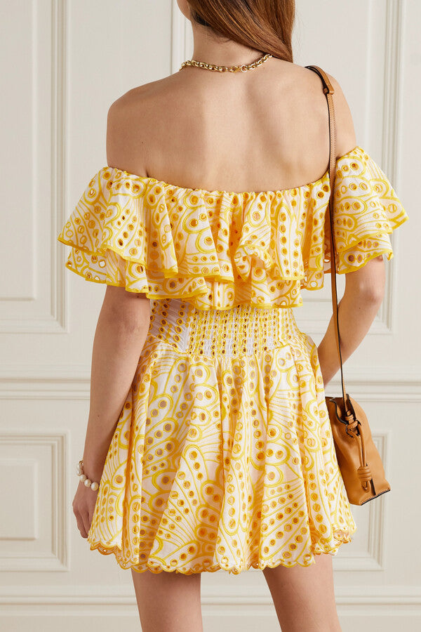 The Dalia Off-the-shoulder Mini Dress by Charo Ruiz Ibiza showcases delicate broderie anglaise embroidery on a breathable cotton-blend fabric. Its ruffled neckline enhances a sophisticated yet playful silhouette, perfect for warm-weather occasions. The yellow hue adds a vibrant touch, making this dress an elegant choice for stylish summer outings or resort wear.