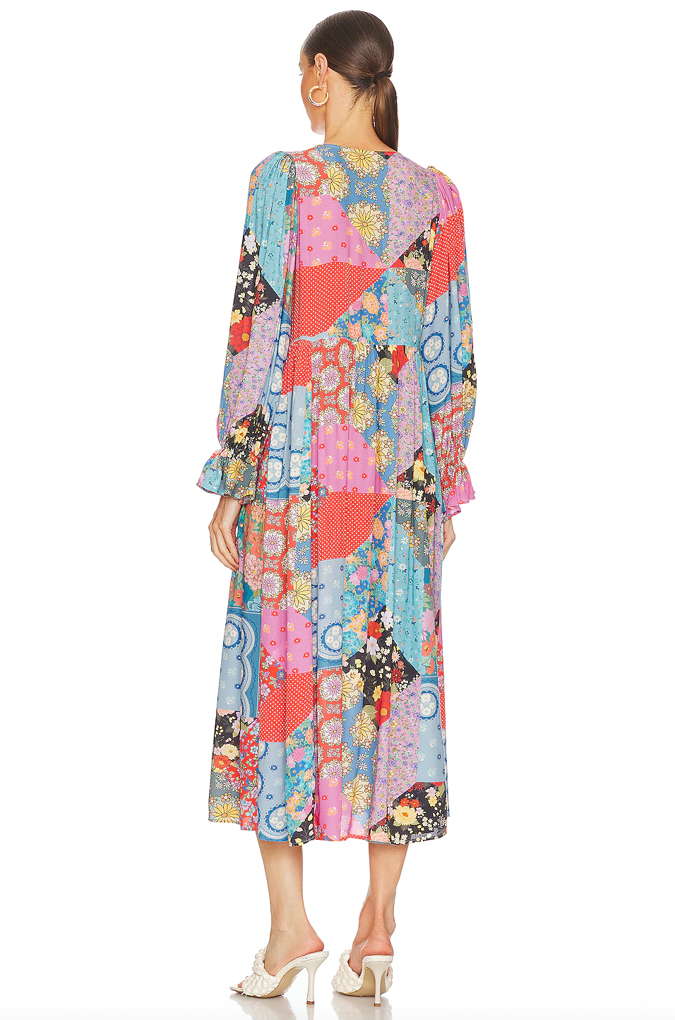 The Cha Cha Boho Midi Dress by Spell offers effortless style with its unlined, lightweight, and airy fabric, perfect for warm weather. It features a convenient pull-on design complemented by a partial front button closure for easy wear. The tie detail at the neckline with tasseled ends adds a delicate bohemian touch, while the cinched ruffled cuffs enhance the dress's feminine silhouette. This dress blends comfort and sophisticated design, ideal for those seeking a breathable, stylish wardrobe staple.