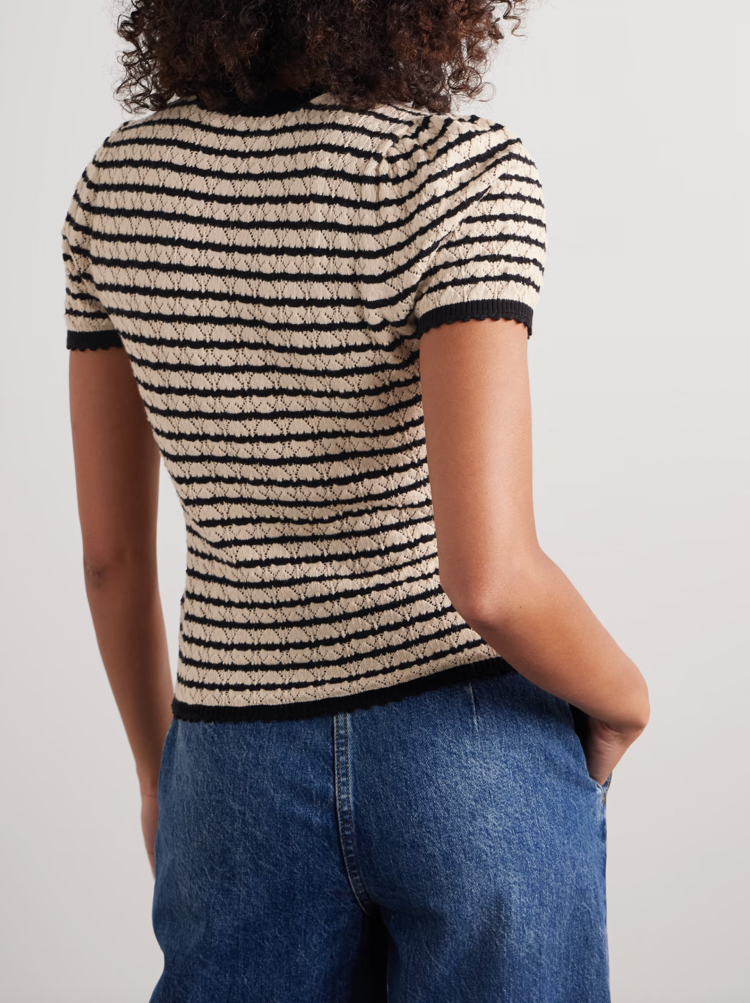 The Brandie striped pointelle-knit top by DÔEN blends cotton and silk for a soft, breathable feel. Its delicate pointelle-knit detailing and contrasting stripes add subtle texture and visual interest. Designed with a slightly loose fit, it features scalloped trims on the crew neckline, short sleeves, and hem for a refined finish.