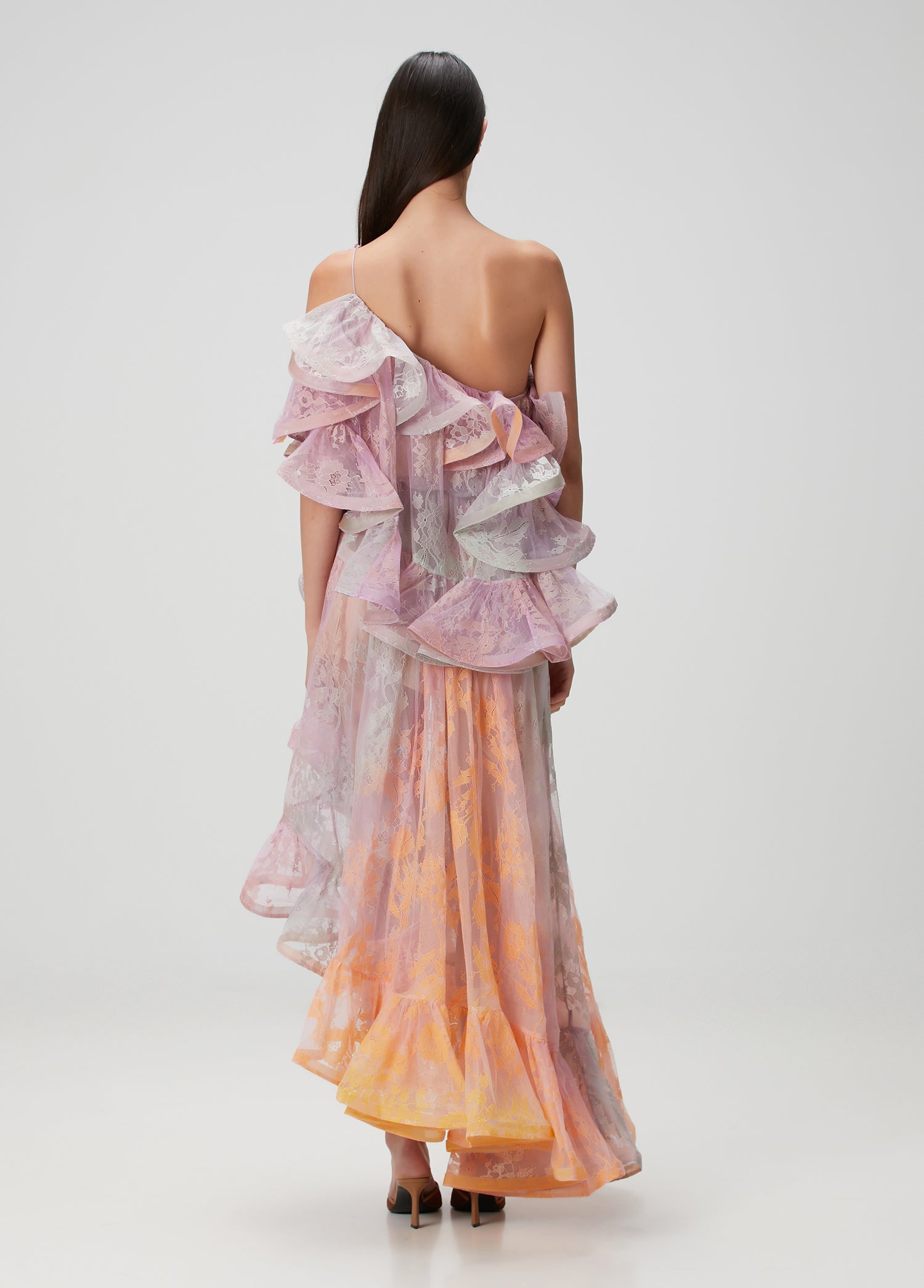 This elegant maxi dress features a distinctive one-shoulder design with an asymmetric neckline that adds a modern touch. Crafted from delicate lace, it offers a refined texture enhanced by flounced detailing and a laced shoulder strap for added sophistication. Perfect for formal occasions, its flowing silhouette ensures graceful movement while highlighting your poise and style.