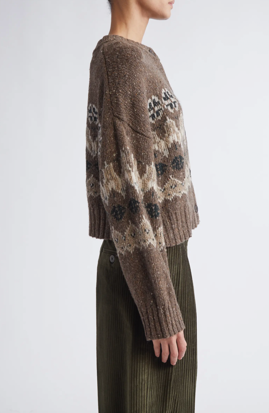 This sophisticated cardigan reimagines classic Fair Isle aesthetics through a contemporary lens, crafted from a textured wool blend that delivers both visual interest and warmth. The dropped-shoulder silhouette creates an effortlessly relaxed fit, while the traditional motif patterns add timeless appeal to your everyday rotation.
