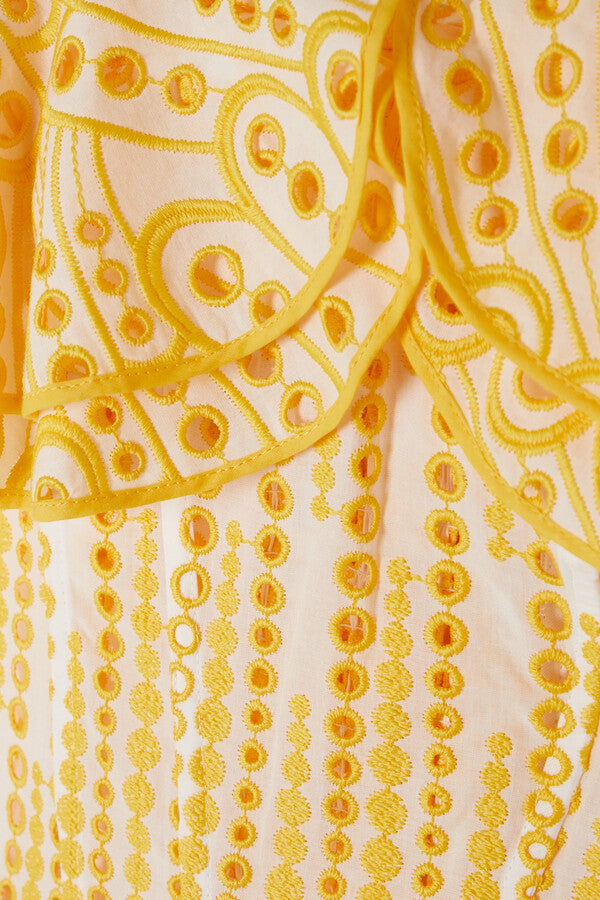 The Dalia Off-the-shoulder Mini Dress by Charo Ruiz Ibiza showcases delicate broderie anglaise embroidery on a breathable cotton-blend fabric. Its ruffled neckline enhances a sophisticated yet playful silhouette, perfect for warm-weather occasions. The yellow hue adds a vibrant touch, making this dress an elegant choice for stylish summer outings or resort wear.
