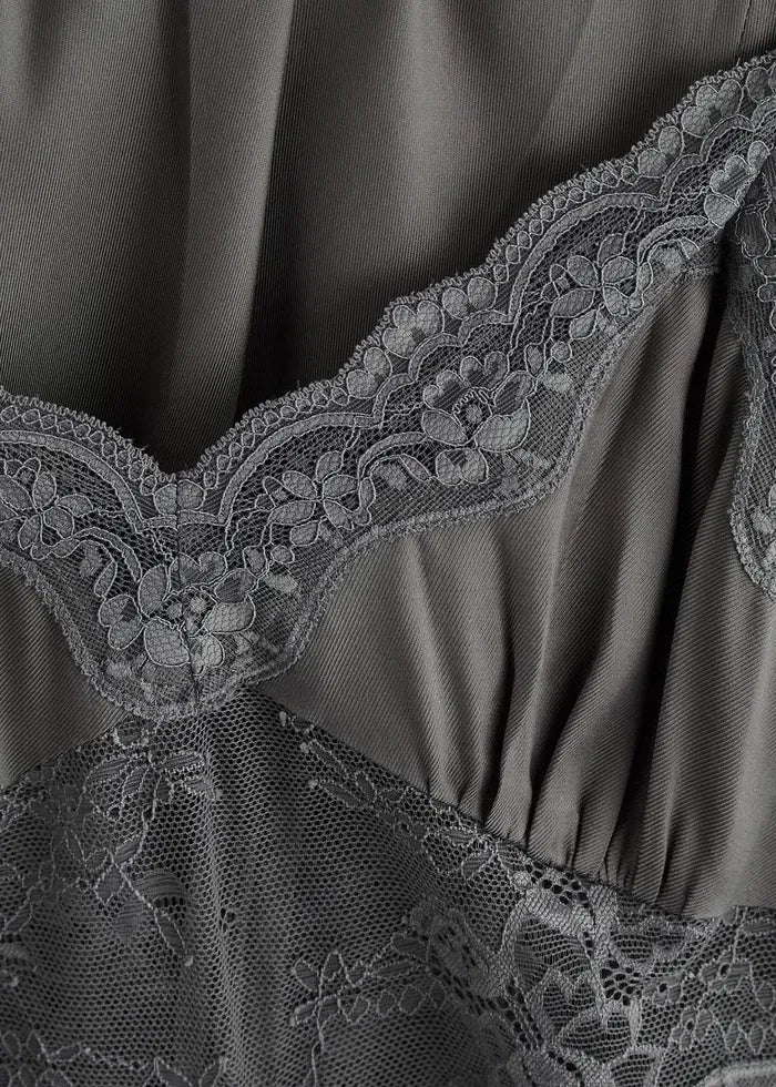 The Amoras Lace-Trimmed Satin Maxi Slip Dress exemplifies sophisticated contemporary design. Its smooth satin fabric drapes elegantly in a flattering maxi silhouette, enhanced by delicate lace trim to add refinement. Perfect for occasions requiring understated luxury, this dress seamlessly blends modern style with timeless elegance, embodying the confident color palette and sleek tailoring signature to its Australian heritage.