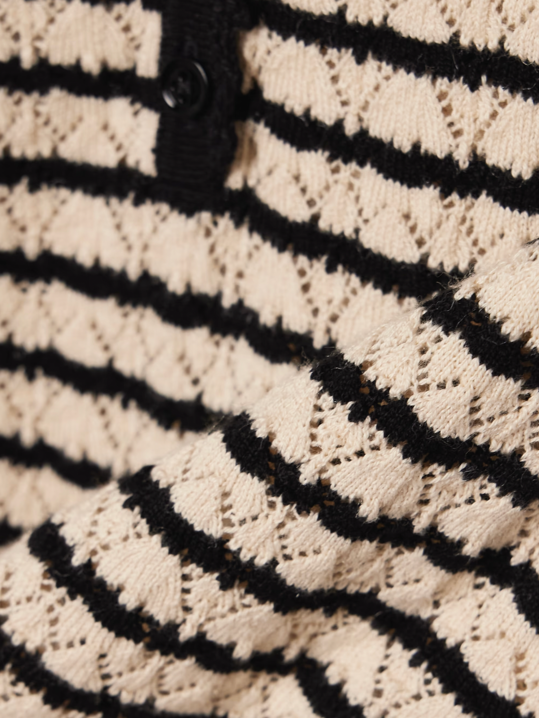 The Brandie striped pointelle-knit top by DÔEN blends cotton and silk for a soft, breathable feel. Its delicate pointelle-knit detailing and contrasting stripes add subtle texture and visual interest. Designed with a slightly loose fit, it features scalloped trims on the crew neckline, short sleeves, and hem for a refined finish.