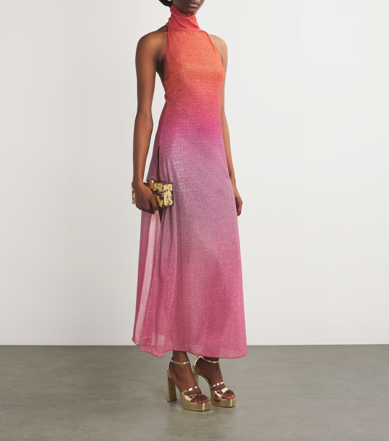 Experience elegance and modern sophistication with the OSÉREE Lumière Ombrè Metallic Stretch-Knit Halterneck Maxi Dress. Crafted from shimmering metallic stretch-knit fabric, this dress offers both comfort and a flattering fit that contours your silhouette. The ombrè effect adds depth and visual interest, while the halterneck design highlights the shoulders for a graceful, refined look.