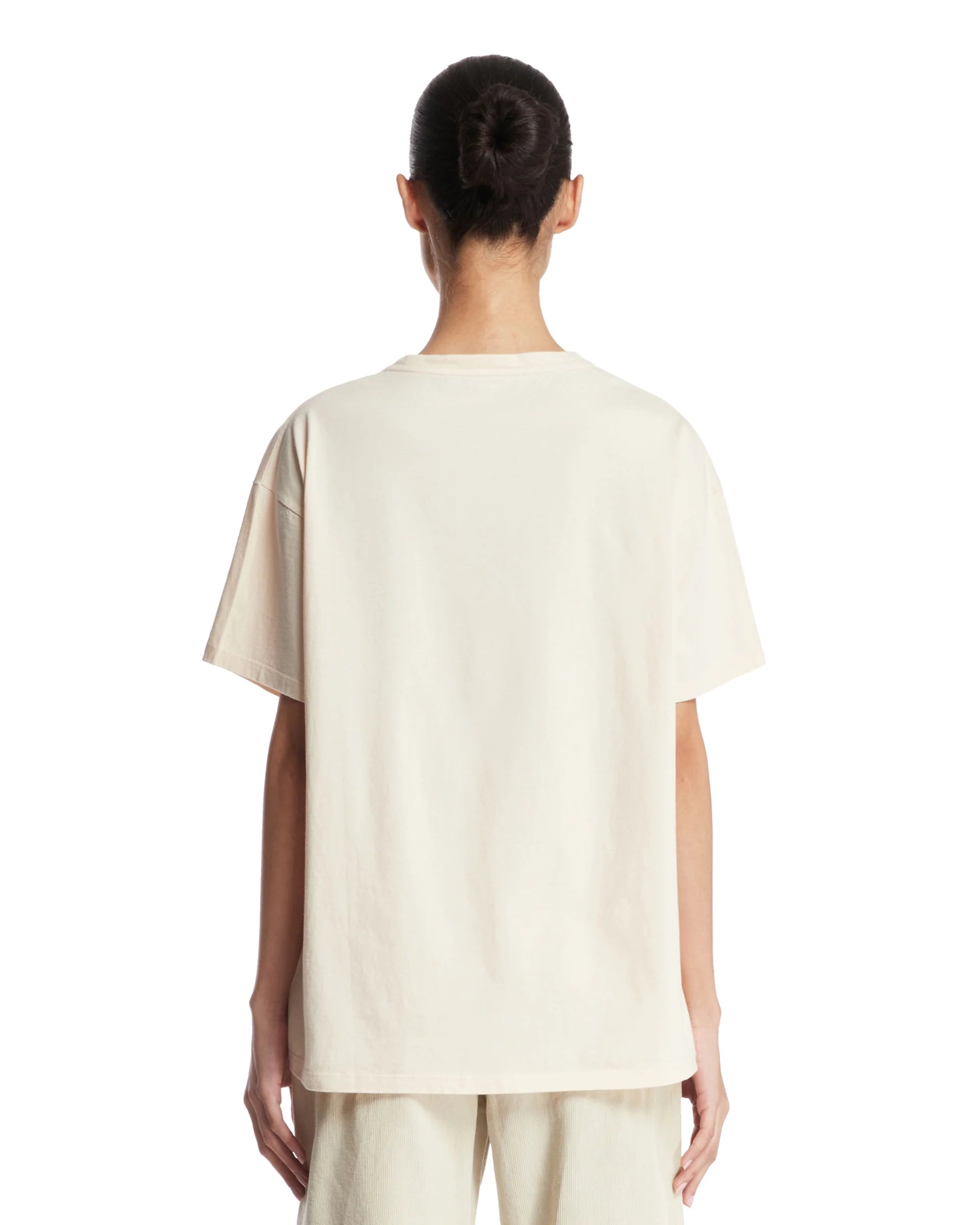 The Beige Nadina Oversized T-shirt from The Row combines effortless style and comfort. Crafted from soft beige cotton, it features a classic crew neckline, short sleeves, and a straight hem for a clean silhouette. Its oversized fit is thoughtfully enhanced with ribbed details, adding subtle texture and structure. This versatile piece offers a relaxed yet refined look, ideal for layering or wearing alone with ease.