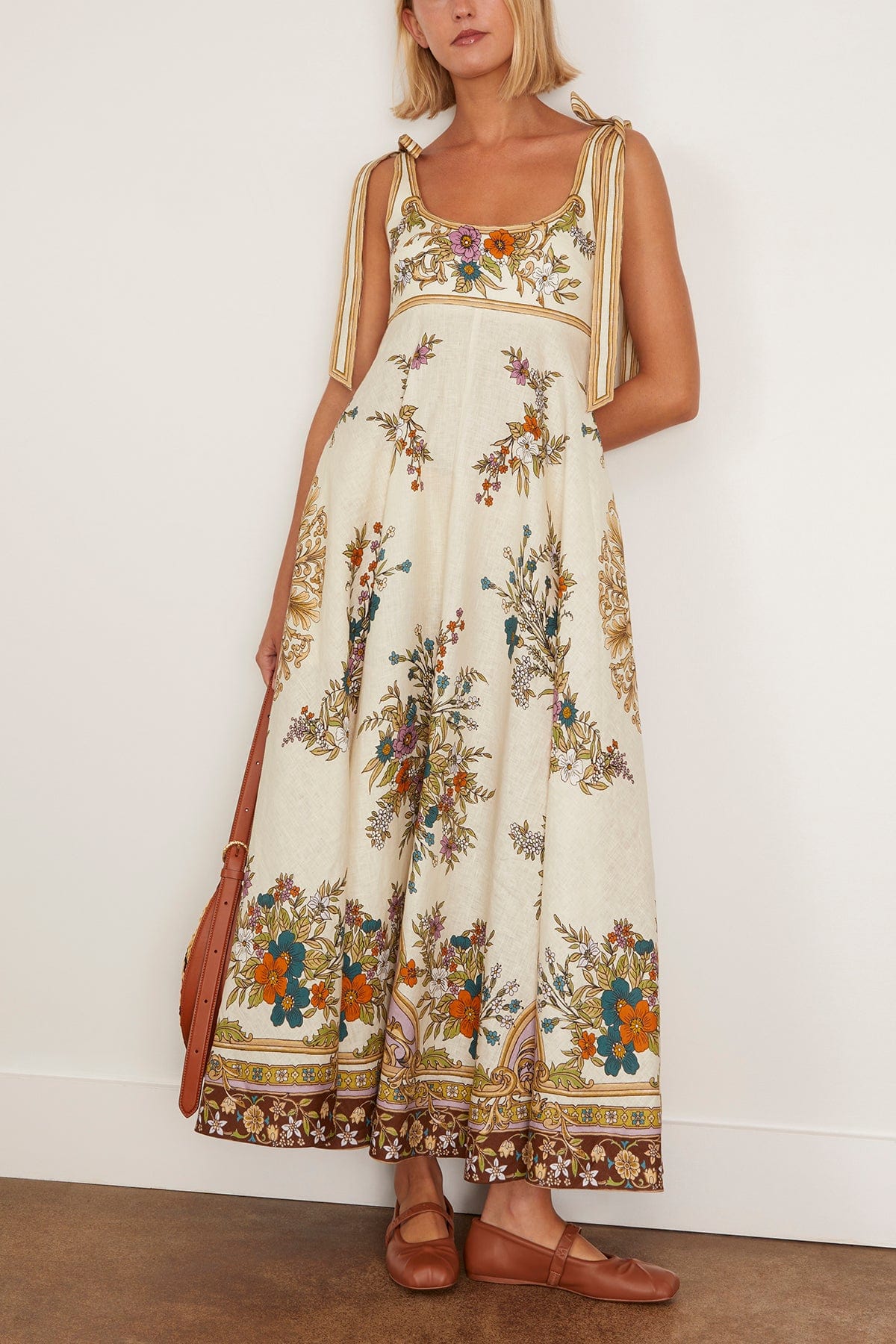 The Antoinette Ballet Sundress in Cream features Alemais’s standout print of the season, designed with an elegant empire waistline that flatters a variety of figures. Its midi length and full skirt create a graceful silhouette, while the shirred back and concealed zipper ensure a comfortable, seamless fit. Adjustable tie shoulders add a delicate touch, making this dress versatile for daytime outings when paired with flats and a tote.