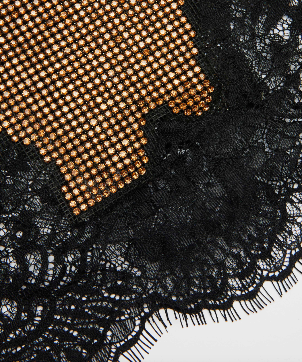 Elevate your evening look with this Brown Crystal Mini Skirt by self-portrait, featuring delicate lace trims that bring a sophisticated boudoir flair. Crafted in a fitted silhouette with minimal stretch, it offers a sleek shape complemented by a convenient back zip closure. The unlined design keeps it light, while the crystal chainmail fabric adds a subtle shimmer. Pair it with a simple tee and flats for effortless date night style, or combine it with the matching top and heels for a striking party ensemble