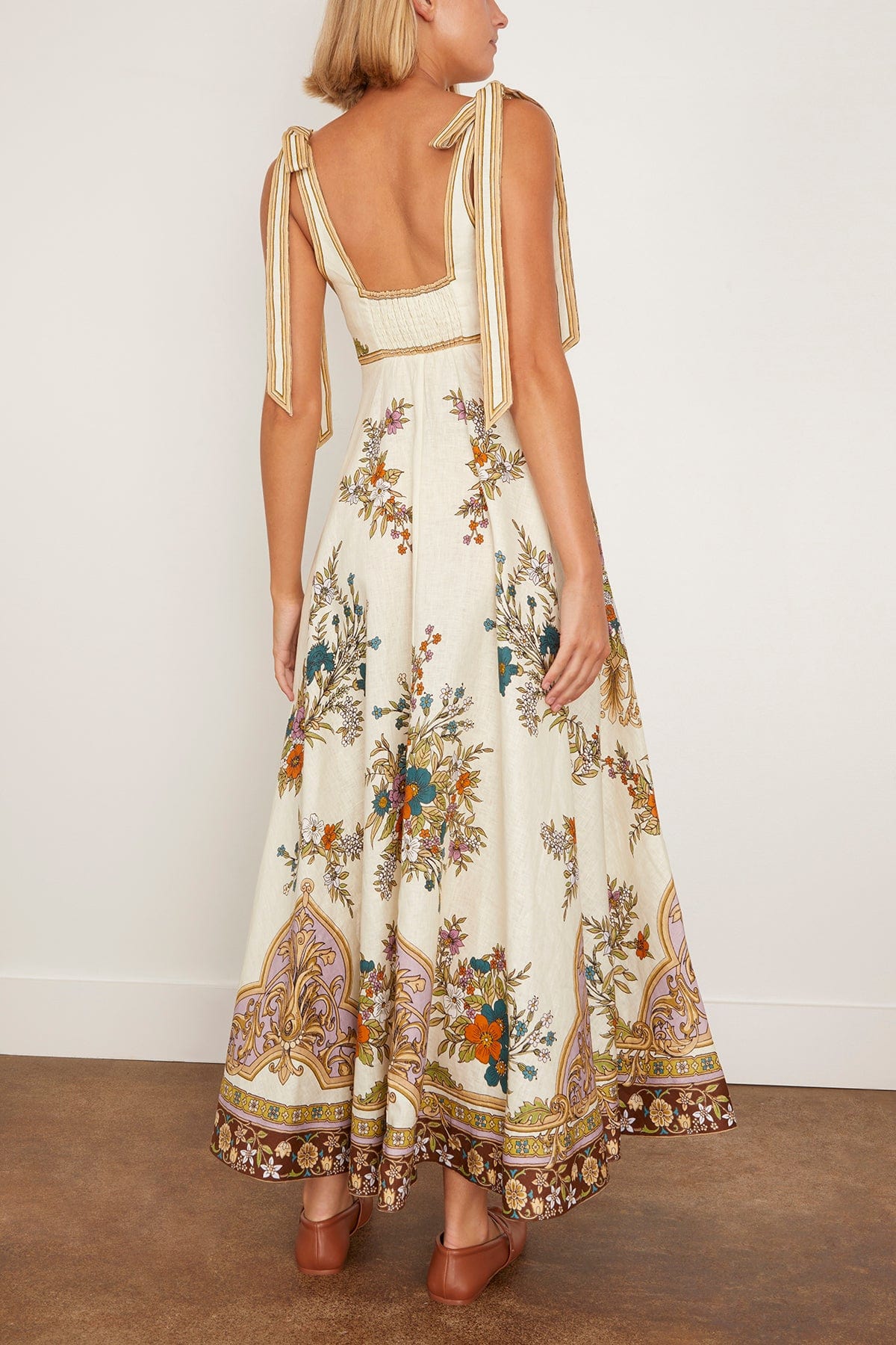 The Antoinette Ballet Sundress in Cream features Alemais’s standout print of the season, designed with an elegant empire waistline that flatters a variety of figures. Its midi length and full skirt create a graceful silhouette, while the shirred back and concealed zipper ensure a comfortable, seamless fit. Adjustable tie shoulders add a delicate touch, making this dress versatile for daytime outings when paired with flats and a tote.