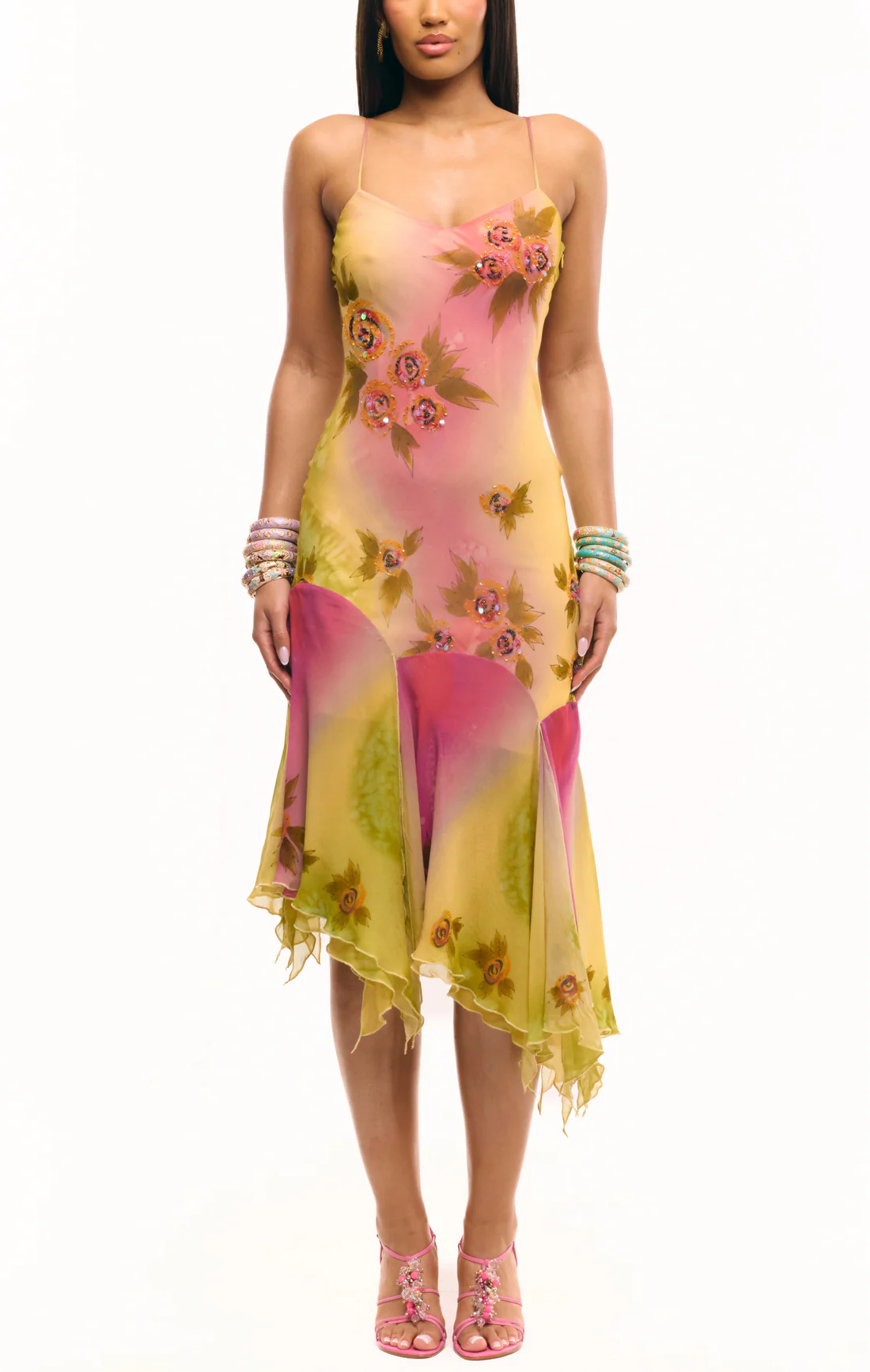 Crafted entirely by hand, the Coral Midi Dress showcases exquisite silk fabric detailed with intricate beadwork and custom floral embellishments in a captivating green and pink gradient watercolor. Its asymmetrical silhouette offers a unique, elegant shape that commands attention, making it a standout choice for refined occasions.