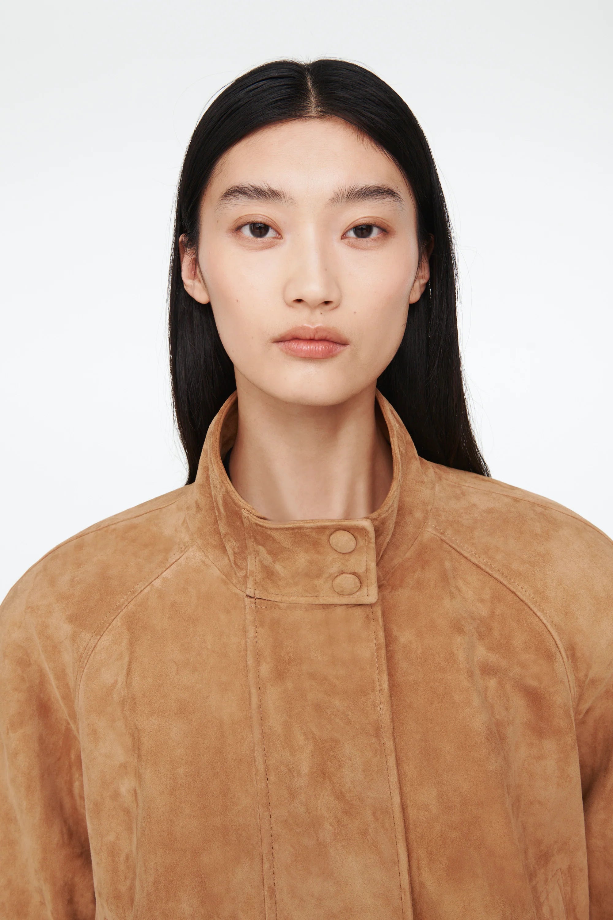 The Anastasia Suede Jacket by Ducie London offers a refined take on the classic aviator style, featuring a short stand collar that enhances its sleek profile. Its adjustable hem with drawstrings allows for a personalized fit, ensuring comfort and versatility. Crafted for enduring appeal, this jacket combines timeless design with functional details, making it a dependable choice for layering across seasons.