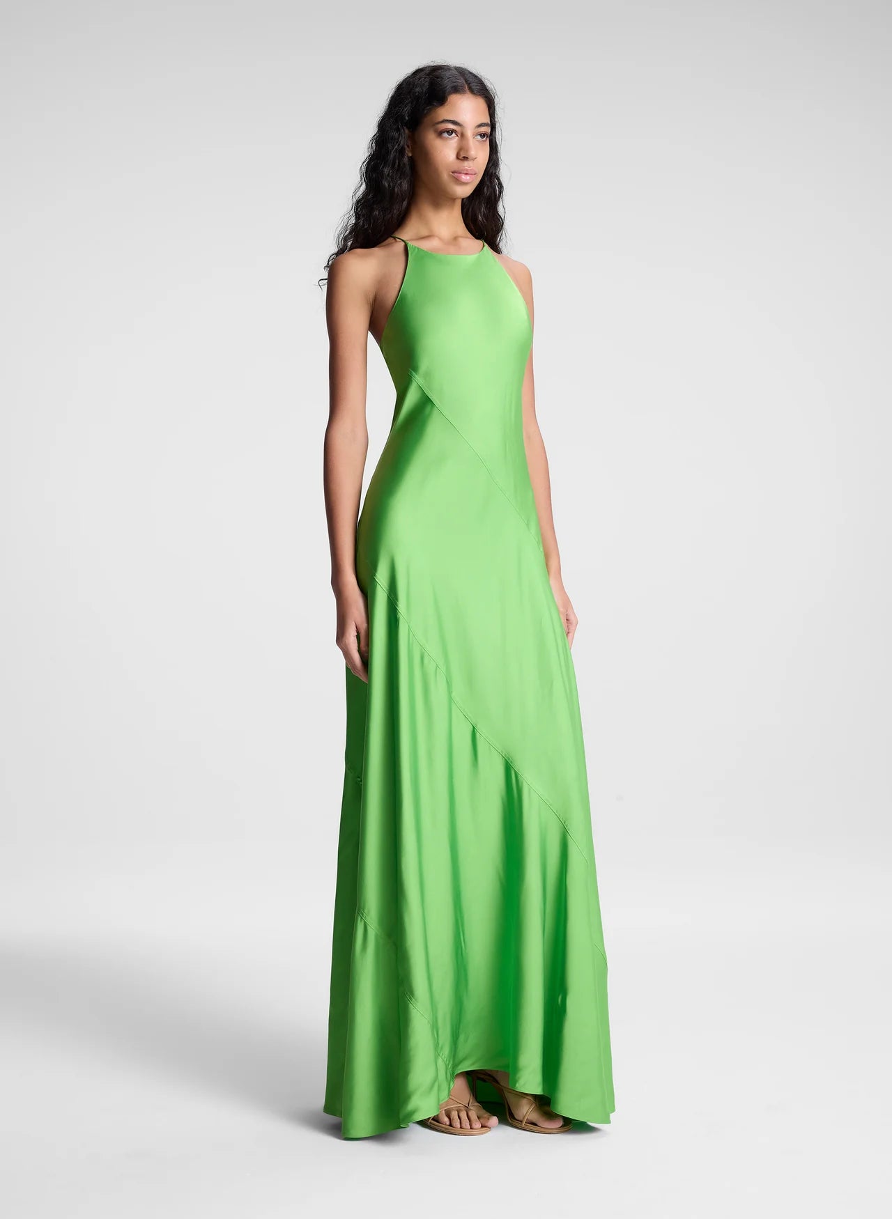 The Sybil Satin Maxi Dress by A.L.C showcases the refined elegance of fluid viscose satin in a striking lime green. Its bias-cut construction creates a graceful, body-skimming silhouette that moves with you, while the high halter neckline and delicate straps deliver a sculpted, sophisticated look. Perfect for elevated occasions where understated luxury speaks volumes.