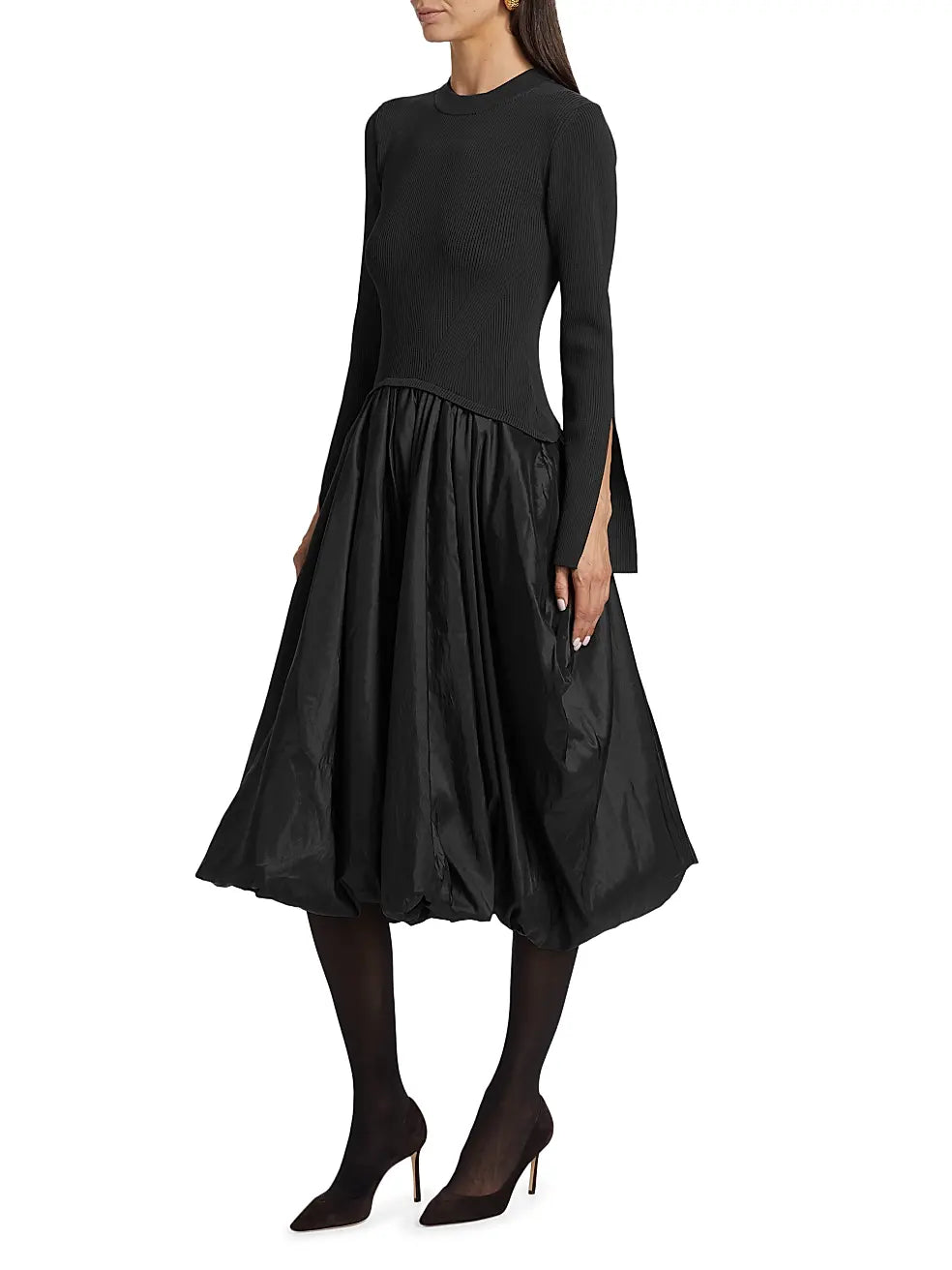 The Kenlie Mixed-Media Bubble Skirt Midi-Dress by SIMKHAI combines a sleek rib-knit top with a distinctive bubble skirt for a refined silhouette. It features a comfortable crewneck and elegant long split sleeves, enhancing both style and ease of movement. Designed to pull over effortlessly, this dress balances modern structure with feminine volume, making it a standout choice for sophisticated occasions.