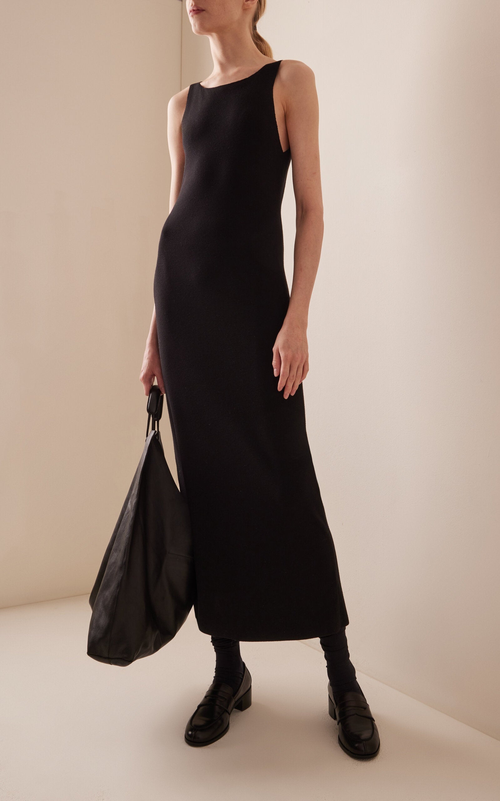 Crafted from fine technical wool, the Florio Dress in Stretch Wool by The Row offers a tailored fit that gently contours the body. Its ankle-length silhouette and thin straps create a refined, modern look, while the wide neckline adds subtle elegance. Ideal for sophisticated occasions, this dress combines comfort and style with the breathable, flexible qualities of stretch wool.