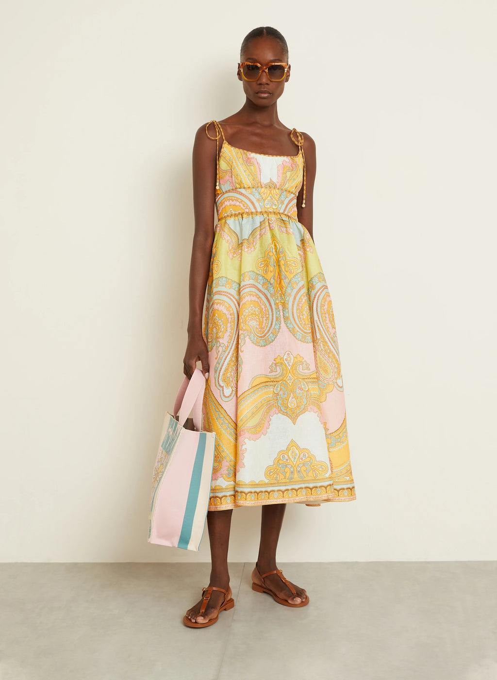 The Maxine Picnic Midi Dress by Zimmermann combines expert tailoring with breathable linen fabric for optimal comfort on warm days. Its boned bodice and smocked back provide a structured yet adaptable fit, while self-tie shoulder straps and a hidden back zipper maintain a sleek profile. Unlined for lightweight wear, this dress also includes practical side seam pockets, balancing functionality with refined style—ideal for sophisticated summer occasions.