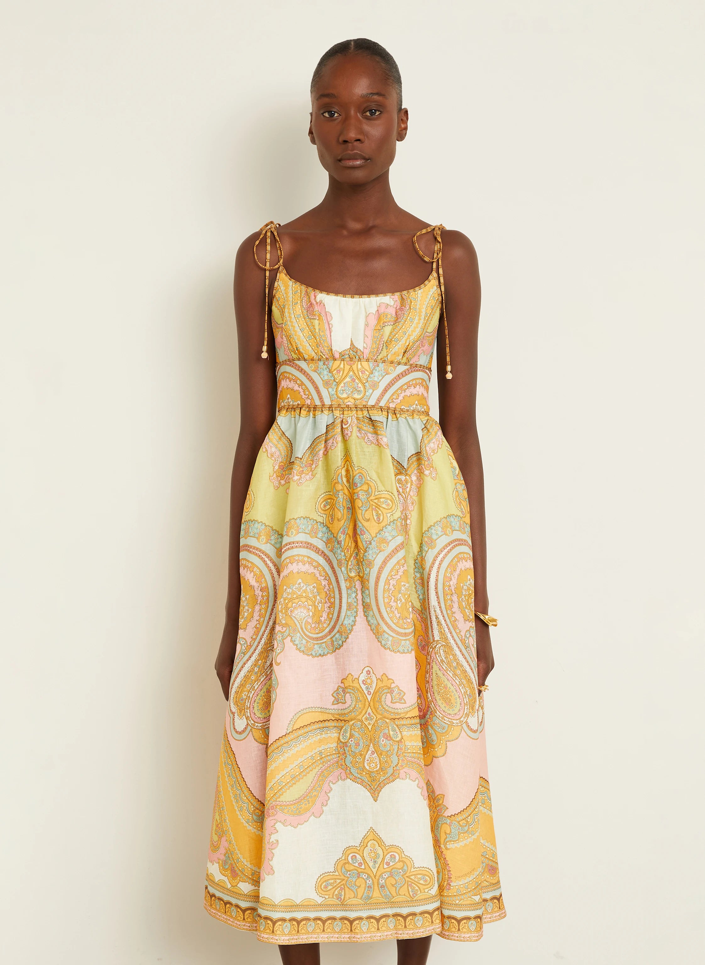 The Maxine Picnic Midi Dress by Zimmermann combines expert tailoring with breathable linen fabric for optimal comfort on warm days. Its boned bodice and smocked back provide a structured yet adaptable fit, while self-tie shoulder straps and a hidden back zipper maintain a sleek profile. Unlined for lightweight wear, this dress also includes practical side seam pockets, balancing functionality with refined style—ideal for sophisticated summer occasions.