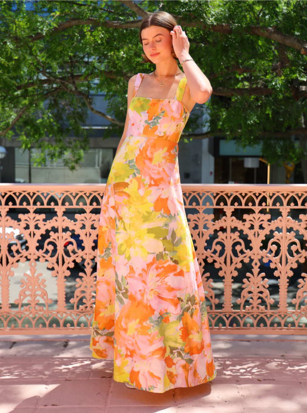 The Goldie Maxi Dress in Floral Confetti by Nicola offers a refined silhouette with a fully lined design and elegant circle skirt for graceful movement. Its wide straps and straight neckline highlight a flattering shape, while the delicate floral confetti pattern adds a soft, romantic touch. Finished with a discreet center-back zip, this dress ensures a seamless fit, making it an ideal choice for garden parties, weddings, or any event where effortless elegance is desired. 