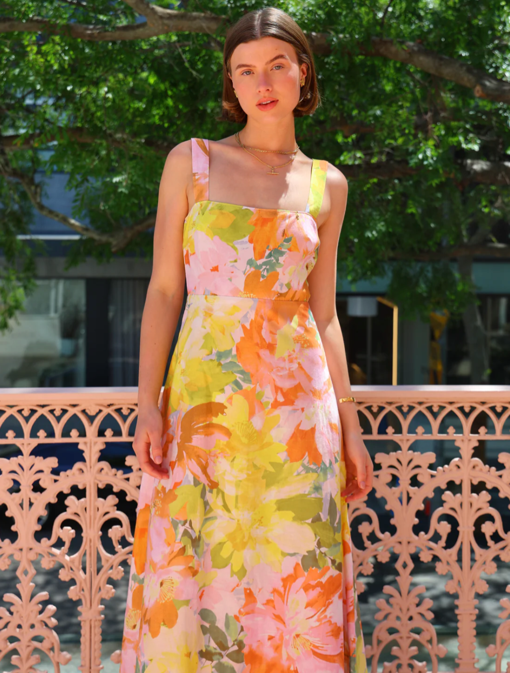 The Goldie Maxi Dress in Floral Confetti by Nicola offers a refined silhouette with a fully lined design and elegant circle skirt for graceful movement. Its wide straps and straight neckline highlight a flattering shape, while the delicate floral confetti pattern adds a soft, romantic touch. Finished with a discreet center-back zip, this dress ensures a seamless fit, making it an ideal choice for garden parties, weddings, or any event where effortless elegance is desired. 