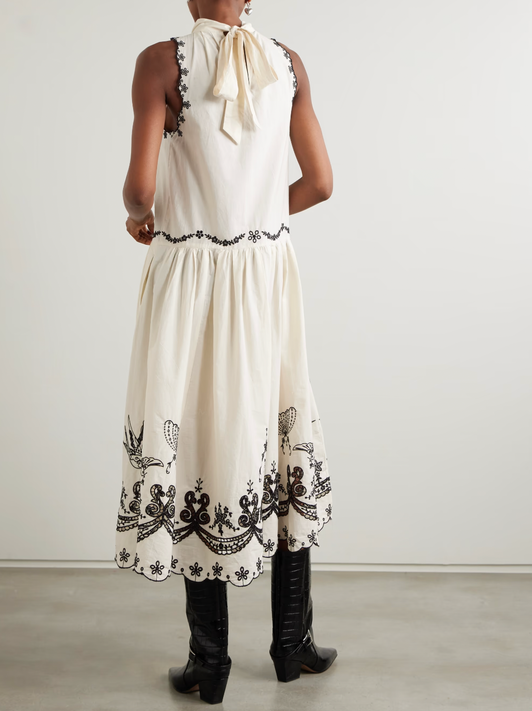 The Kingsley embroidered cotton midi dress by SEA NY showcases delicate pleats that elegantly fan out to reveal intricate embroidered birds, flowers, and garlands. Crafted from breathable cotton, it features broderie anglaise cutouts along the hem, adding refined detail and enhancing its airy, sophisticated appeal—ideal for warm-weather occasions requiring both comfort and expert design.
