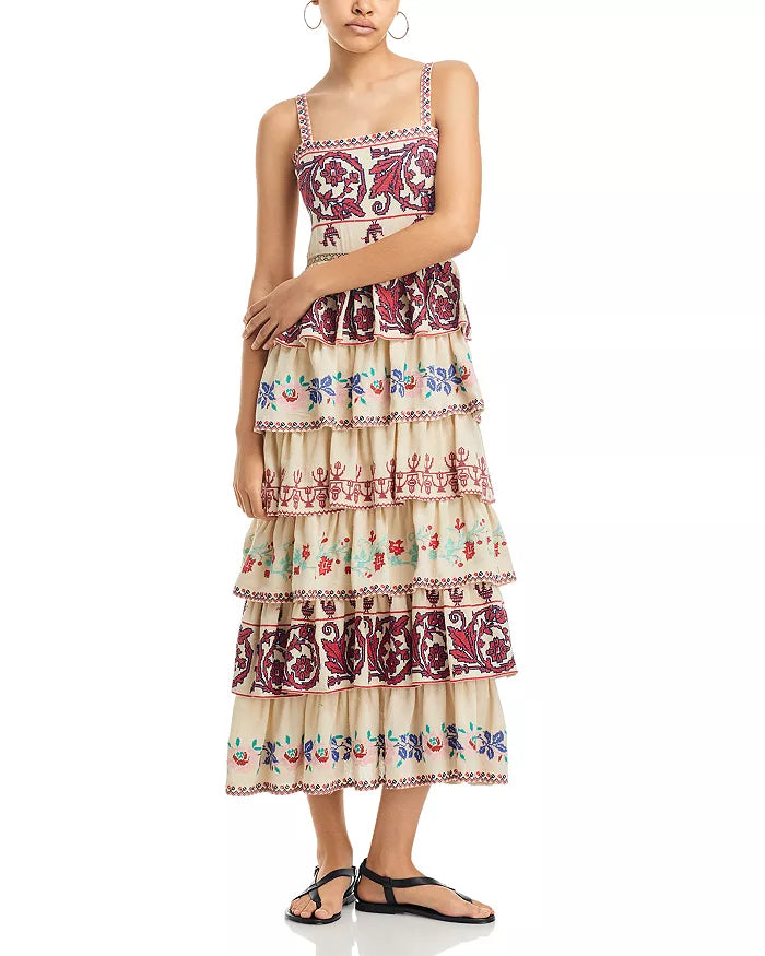The Ramona Embroidered Dress by SEA New York showcases a sophisticated fit-and-flare silhouette with a flattering square neckline and secure back zip closure. Delicate embroidery adorns the entire dress, enhancing its refined appeal, while the tiered ruffle skirt adds movement and dimension. Designed with straps and fully lined for comfort, this piece combines elegance with thoughtful construction. Crafted in India, it exemplifies skilled artistry and attention to detail.