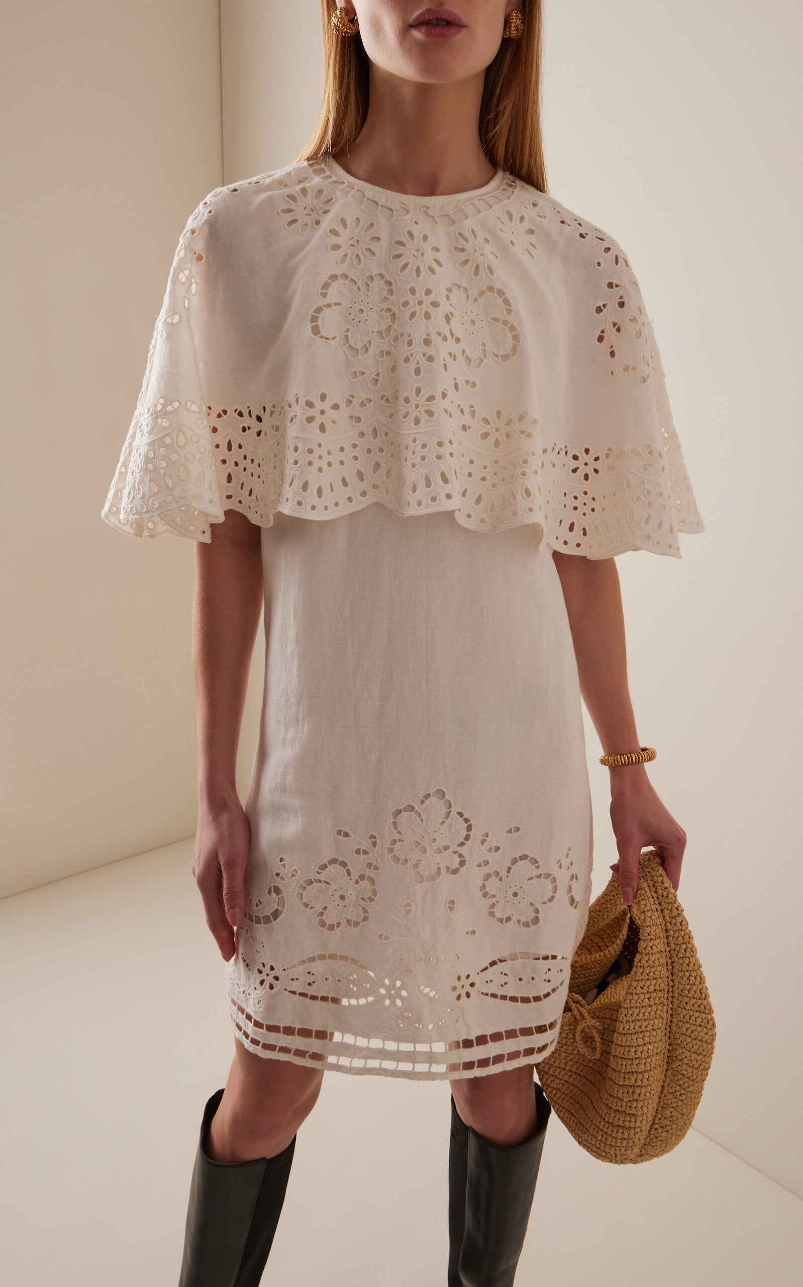 The Lulu Embroidered Linen-Blend Mini Dress by SEA New York combines breathable viscose-linen fabric with delicate eyelet embroidery for a refined texture. Its flouncy capelet adds a sophisticated silhouette, making it an ideal choice for warm-weather occasions where comfort meets understated elegance. This dress offers both lightweight wearability and distinctive design details for a polished, expert look.