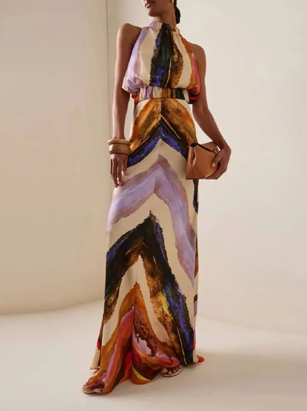 This standout set includes a sleeveless crop top with a halter design that leaves the back exposed, combined with a high-waisted maxi skirt with a modern print. The elongated skirt stylizes the figure, while the top provides a feeling of freshness and sophistication, perfect for summer occasions and casual events with an elegant touch. Its balance between comfort and trend makes this set an ideal choice for those looking for a contemporary and refined look.