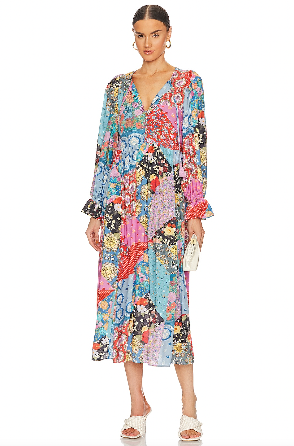 The Cha Cha Boho Midi Dress by Spell offers effortless style with its unlined, lightweight, and airy fabric, perfect for warm weather. It features a convenient pull-on design complemented by a partial front button closure for easy wear. The tie detail at the neckline with tasseled ends adds a delicate bohemian touch, while the cinched ruffled cuffs enhance the dress's feminine silhouette. This dress blends comfort and sophisticated design, ideal for those seeking a breathable, stylish wardrobe staple.