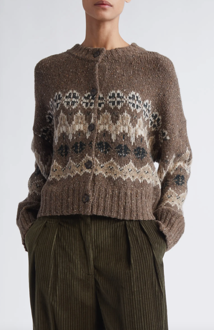 This sophisticated cardigan reimagines classic Fair Isle aesthetics through a contemporary lens, crafted from a textured wool blend that delivers both visual interest and warmth. The dropped-shoulder silhouette creates an effortlessly relaxed fit, while the traditional motif patterns add timeless appeal to your everyday rotation. 