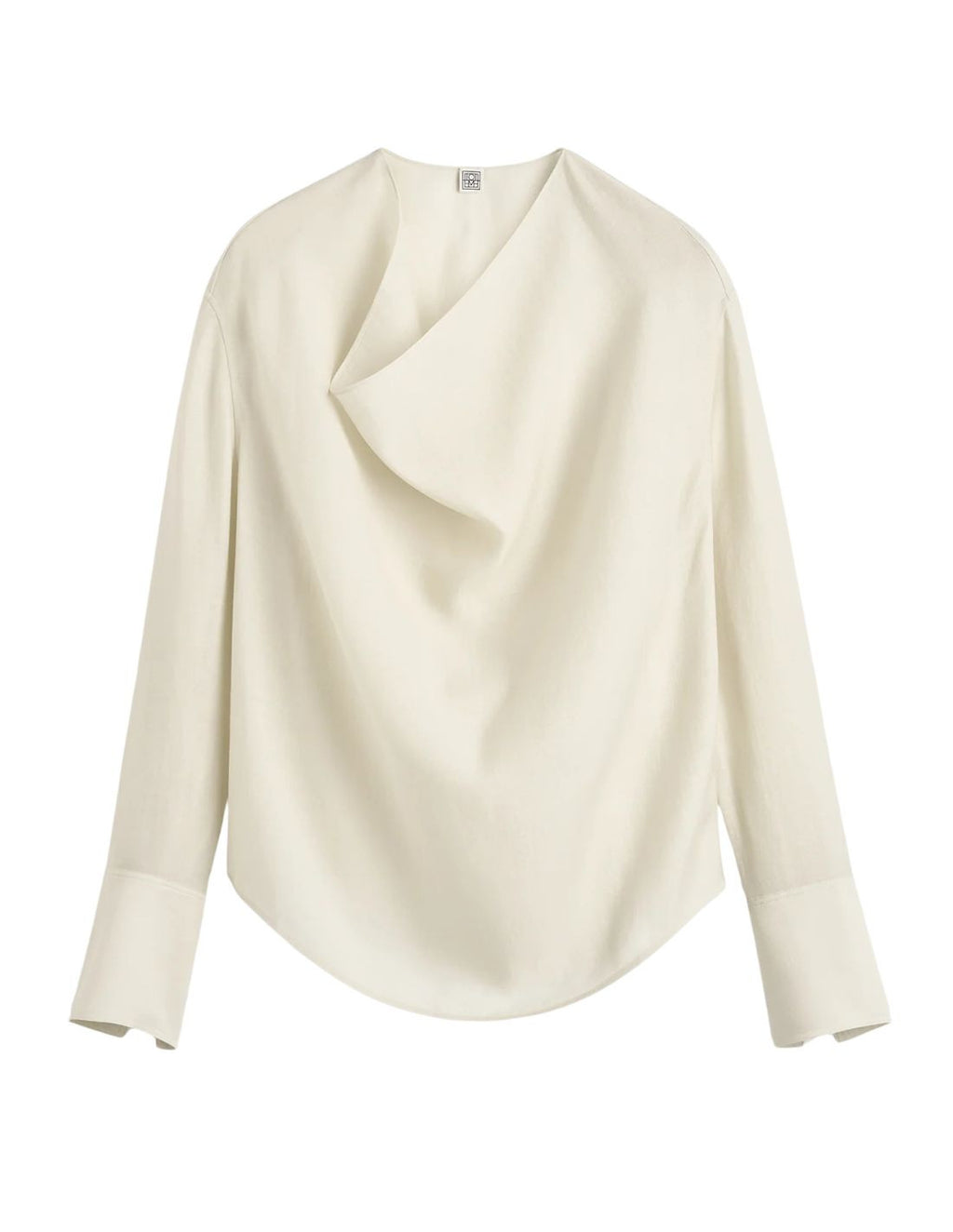 This TOTEME blouse combines refined craftsmanship with effortless style. Crafted from a luxurious blended wool in an elegant ecru shade, its oversized silhouette ensures comfort while maintaining a modern edge. The draped cowl neck creates a sophisticated focal point, complemented by long sleeves finished with buttoned cuffs for a polished look. The curved hem adds subtle fluidity, making this blouse a versatile piece that elevates both casual and formal ensembles with understated elegance.