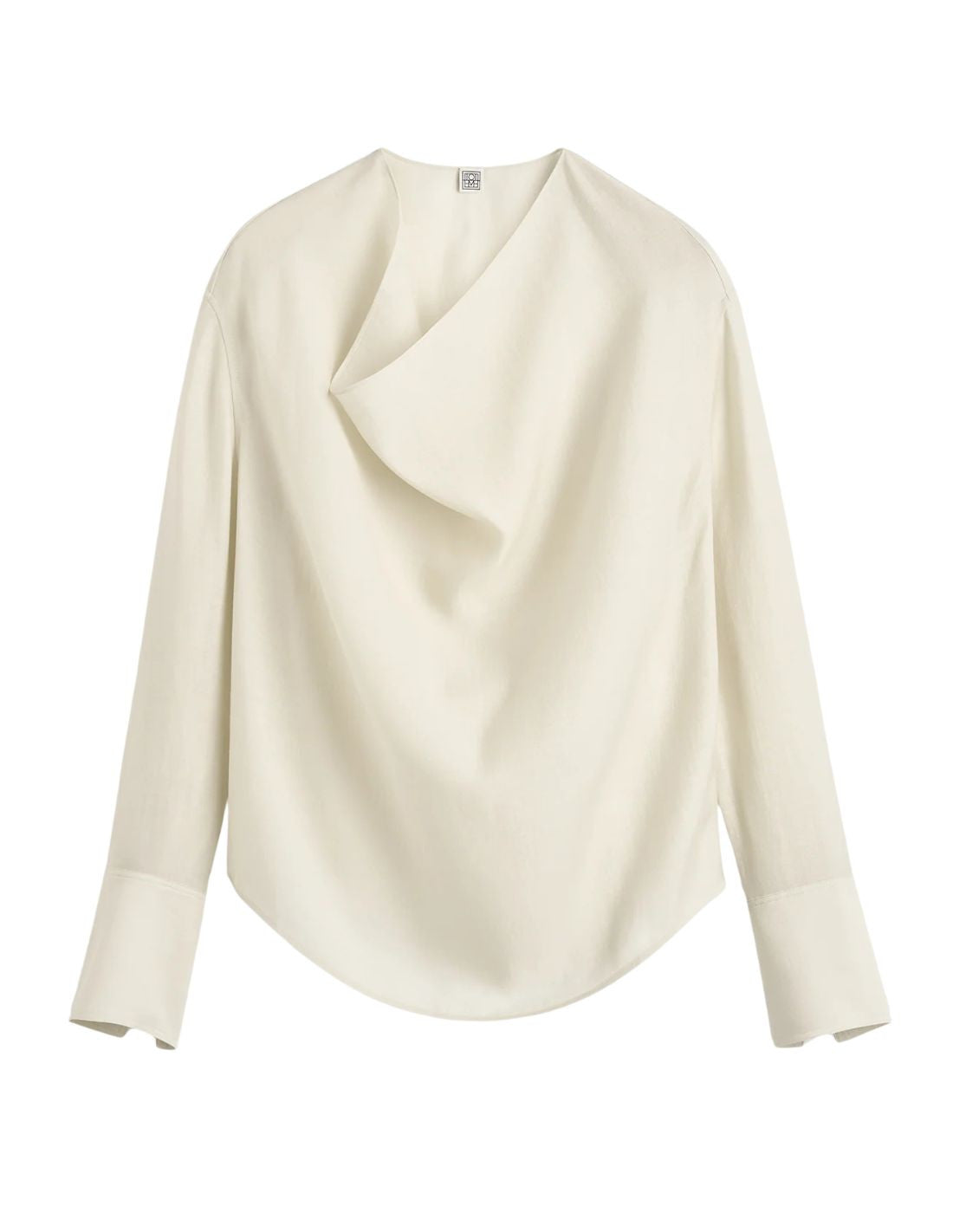 This TOTEME blouse combines refined craftsmanship with effortless style. Crafted from a luxurious blended wool in an elegant ecru shade, its oversized silhouette ensures comfort while maintaining a modern edge. The draped cowl neck creates a sophisticated focal point, complemented by long sleeves finished with buttoned cuffs for a polished look. The curved hem adds subtle fluidity, making this blouse a versatile piece that elevates both casual and formal ensembles with understated elegance.