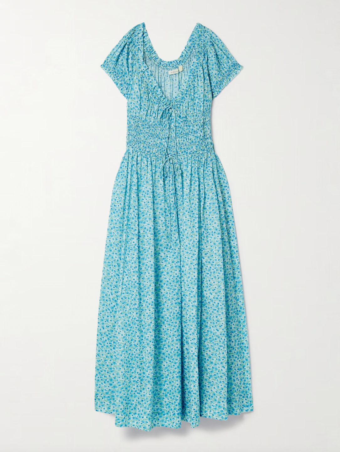 Inspired by the relaxed elegance of Southern California, this Ashlynn midi dress embodies DÔEN's signature romantic aesthetic. Crafted from breathable organic cotton-voile, it features an enchanting all-over floral print that captures effortless sophistication. The shirred bodice provides gentle shaping and comfort, while adjustable ties at the neckline and waist allow you to customize the fit to your preference. 