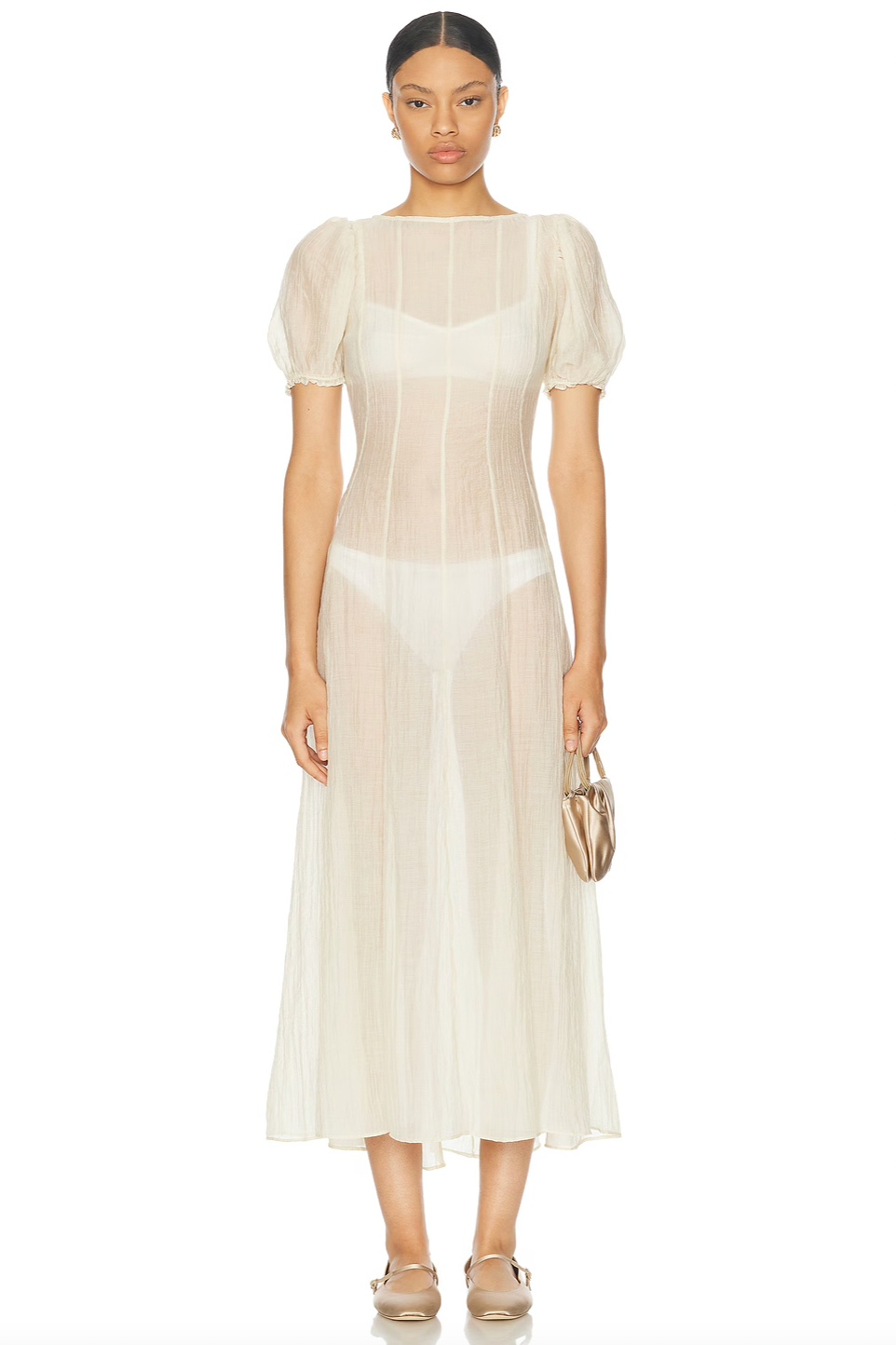 The Emory Dress features soft chiffon fabric and romantic puff sleeves with elastic cuffs for a flattering fit. Its sheer, unlined design gently reveals undergarments (not included), lending an ethereal quality. A discreet back zip maintains a sleek silhouette, while hand washing helps preserve its delicate texture. Ideal for those seeking a sophisticated and modern look with effortless elegance.