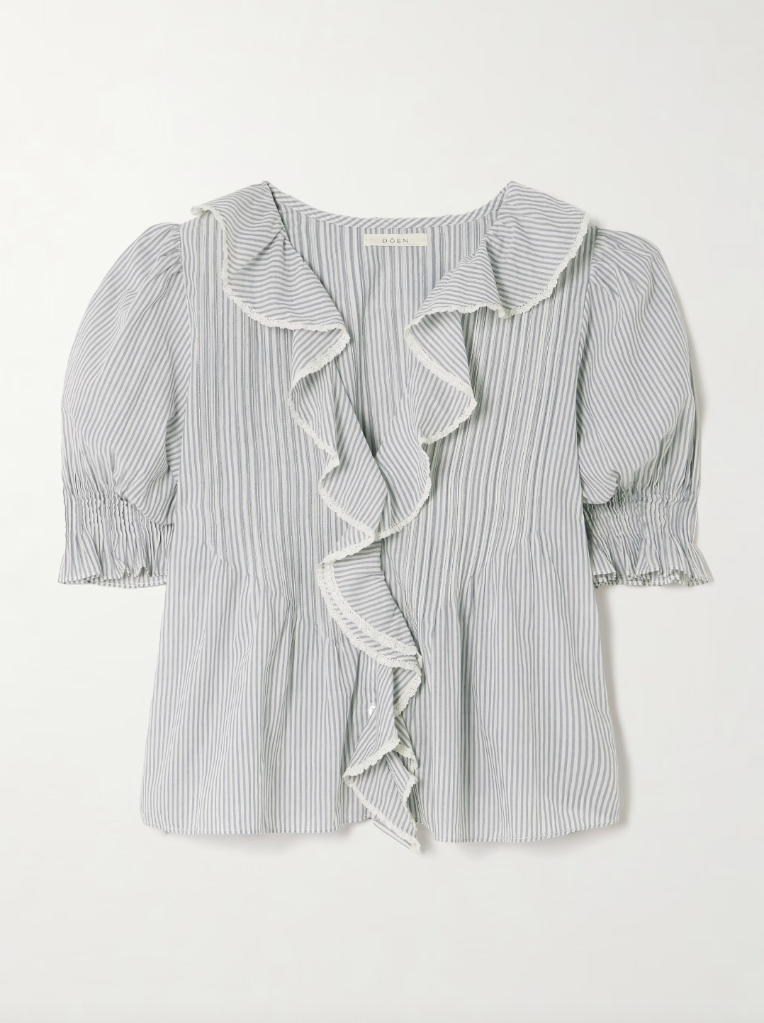DÔEN's Henri top combines delicate detailing with sustainable craftsmanship. Crafted from organic striped cotton-voile, free from harmful pesticides, it features smocked puffed sleeves and lace-trimmed ruffles that frame the neckline. This top offers a refined, airy silhouette perfect for pairing with straight-leg jeans, balancing comfort with a sophisticated, vintage-inspired aesthetic.