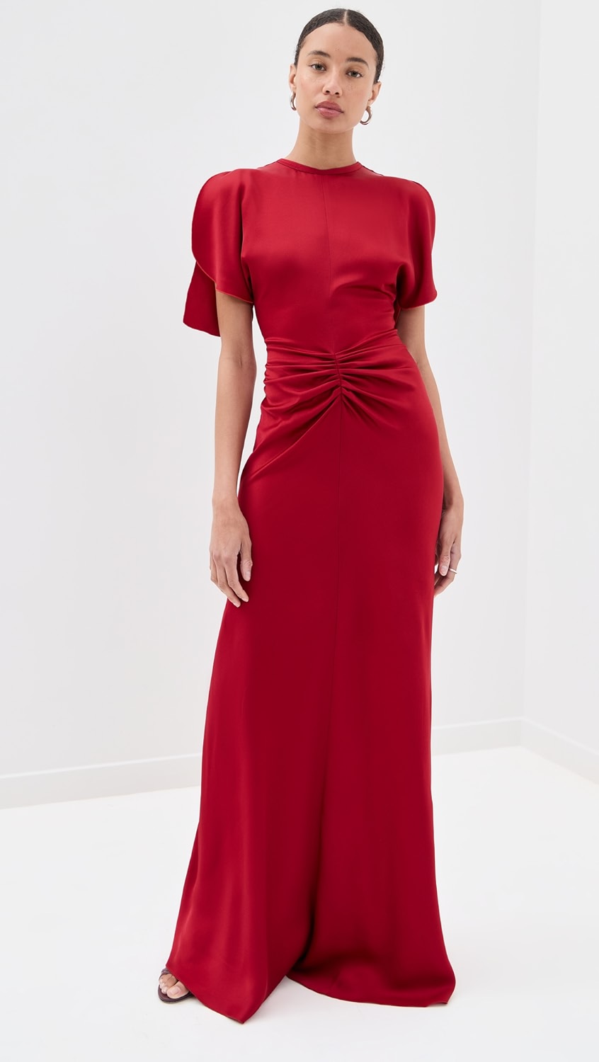 Elegant and refined, this floor-length dress by Victoria Beckham features luxurious mid-weight charmeuse that drapes beautifully without stretch. Strategic ruching at the waist creates a flattering silhouette while the crew neckline and short sleeves offer timeless sophistication. The hidden zip and hook-and-eye closure at the back ensure a seamless finish. Perfect for formal occasions and evening events where polished elegance is paramount.