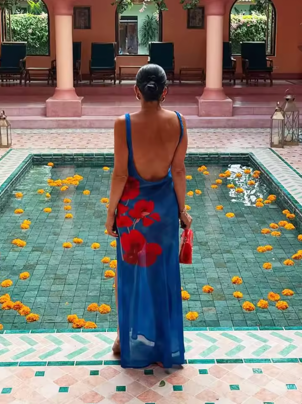 Enhance your style with the stunning Odette Dress. This versatile maxi dress is perfect for any event, featuring a flattering silhouette, high leg split, and charming print. The back cut out, neck tie, and scoop neckline add a touch of elegance to your look. Make a statement with every step in Odette.