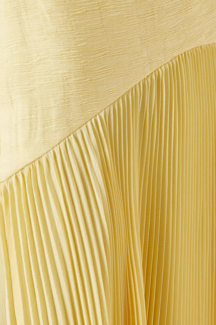 The Sunniva Maxi Dress in Crepe offers a refined silhouette with its boned sides that gently shape your figure, ensuring a flattering fit. Its pleated skirt adds graceful movement, perfect for warm-weather occasions. Designed for minimalism, this dress pairs effortlessly with just a hint of jewelry, making it an expert choice for elegant yet understated summer style.