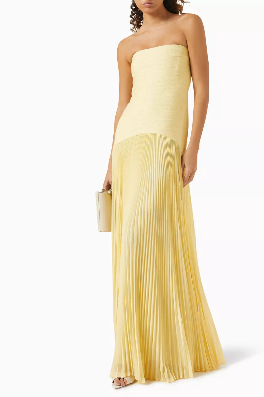 The Sunniva Maxi Dress in Crepe offers a refined silhouette with its boned sides that gently shape your figure, ensuring a flattering fit. Its pleated skirt adds graceful movement, perfect for warm-weather occasions. Designed for minimalism, this dress pairs effortlessly with just a hint of jewelry, making it an expert choice for elegant yet understated summer style.
