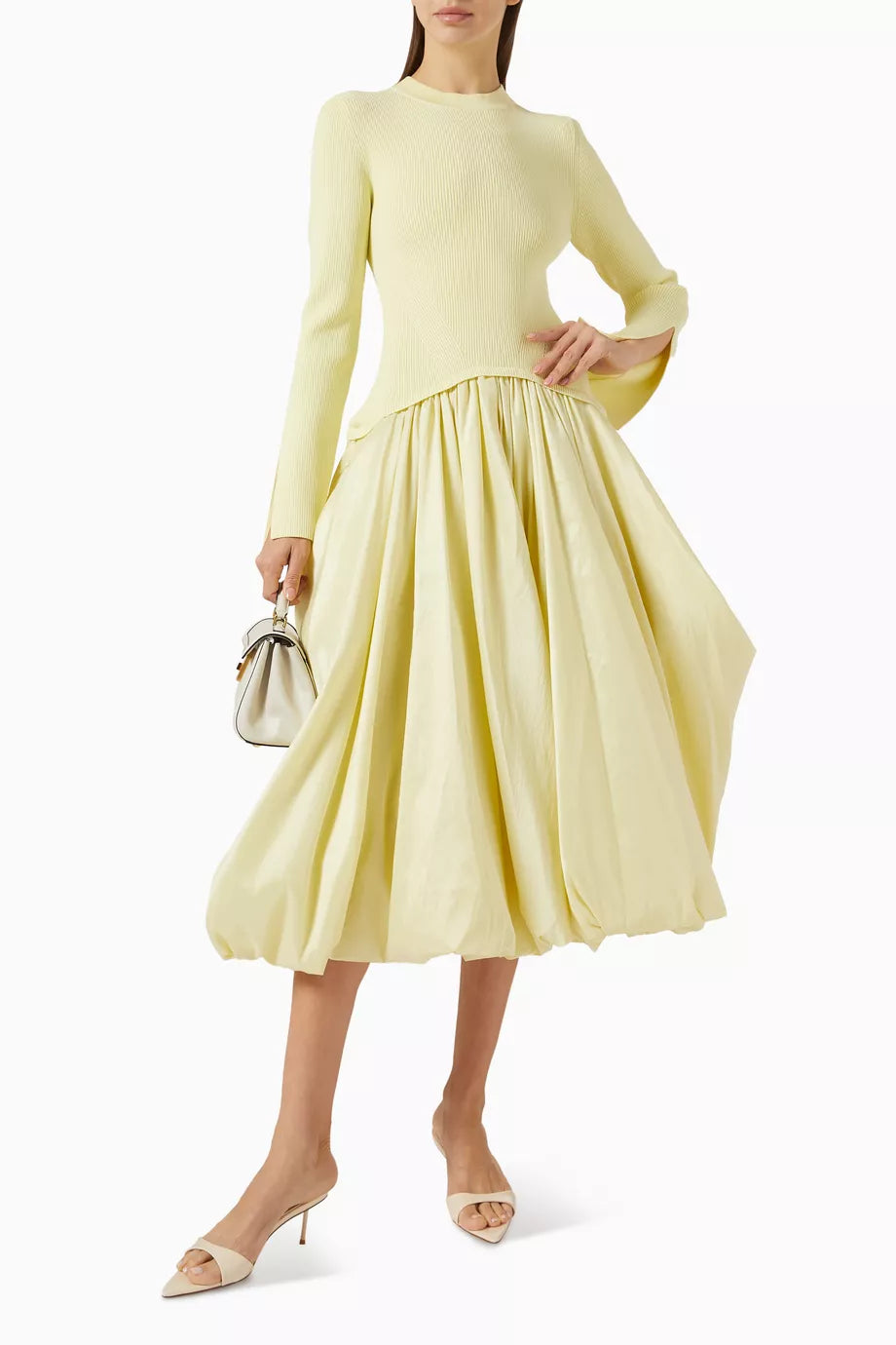 The Kenlie Midi Dress in Rayon Blend by Simkhai offers a sleek minimalist design that expertly enhances your silhouette. Its stretchy knit top contours comfortably, while the A-line skirt creates an elegant hourglass shape. Versatile by nature, this dress seamlessly transitions from casual to refined occasions, delivering both comfort and sophistication with ease.