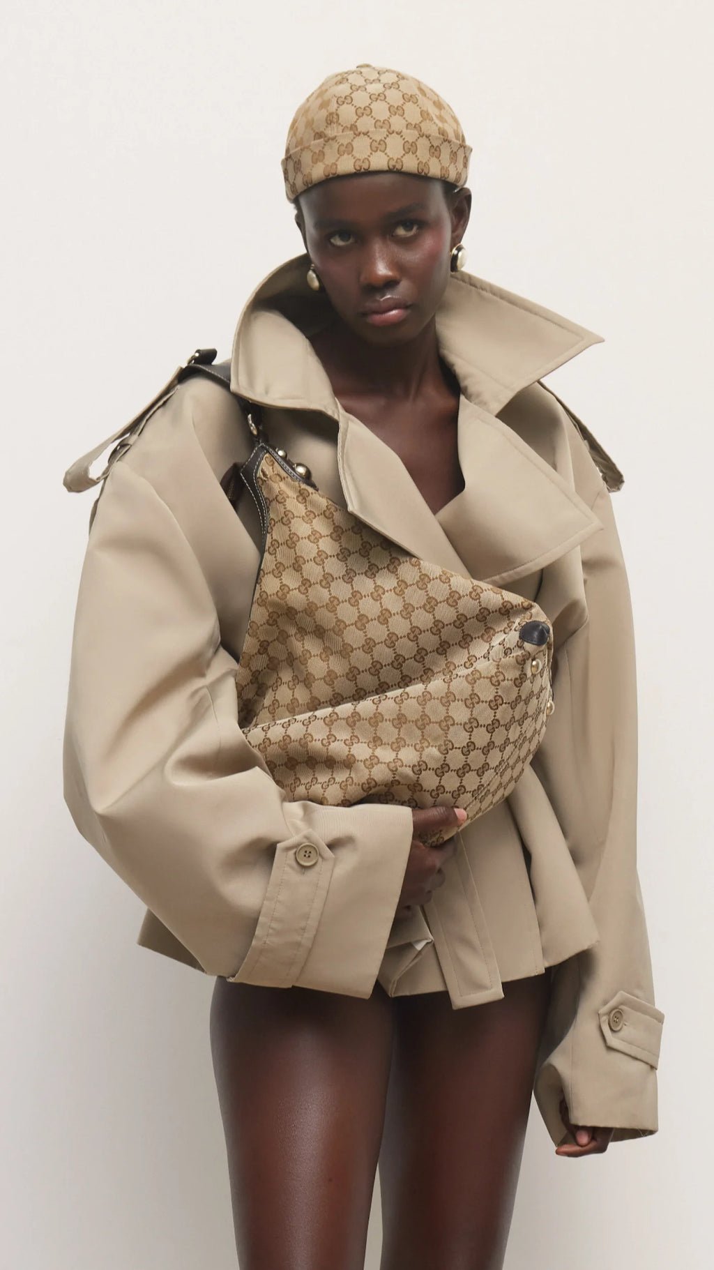 Elevate your wardrobe with this expertly tailored beige trench coat, offering a refined blend of classic design and contemporary appeal. The cropped silhouette enhances layering options, while the neutral beige shade ensures seamless coordination with varied outfits. Crafted for both comfort and style, this trench coat delivers a polished, sophisticated look that adapts effortlessly to different occasions. A versatile essential for a modern, elegant wardrobe.